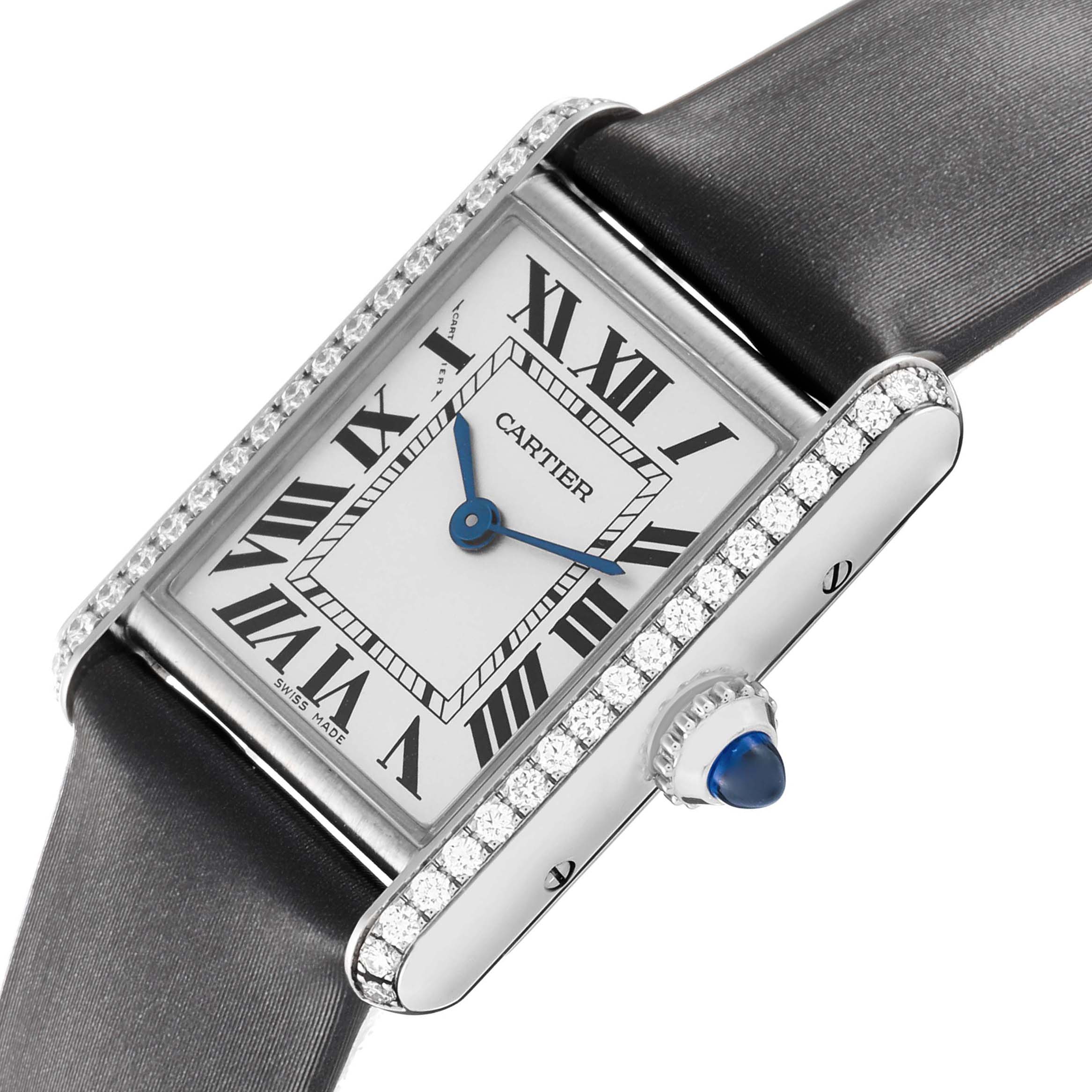 The Cartier Tank Must W4TA0016 Women's Stainless Steel Silver Dial watch is shown at a slight angle, highlighting its diamond-set bezel and blue cabochon crown.