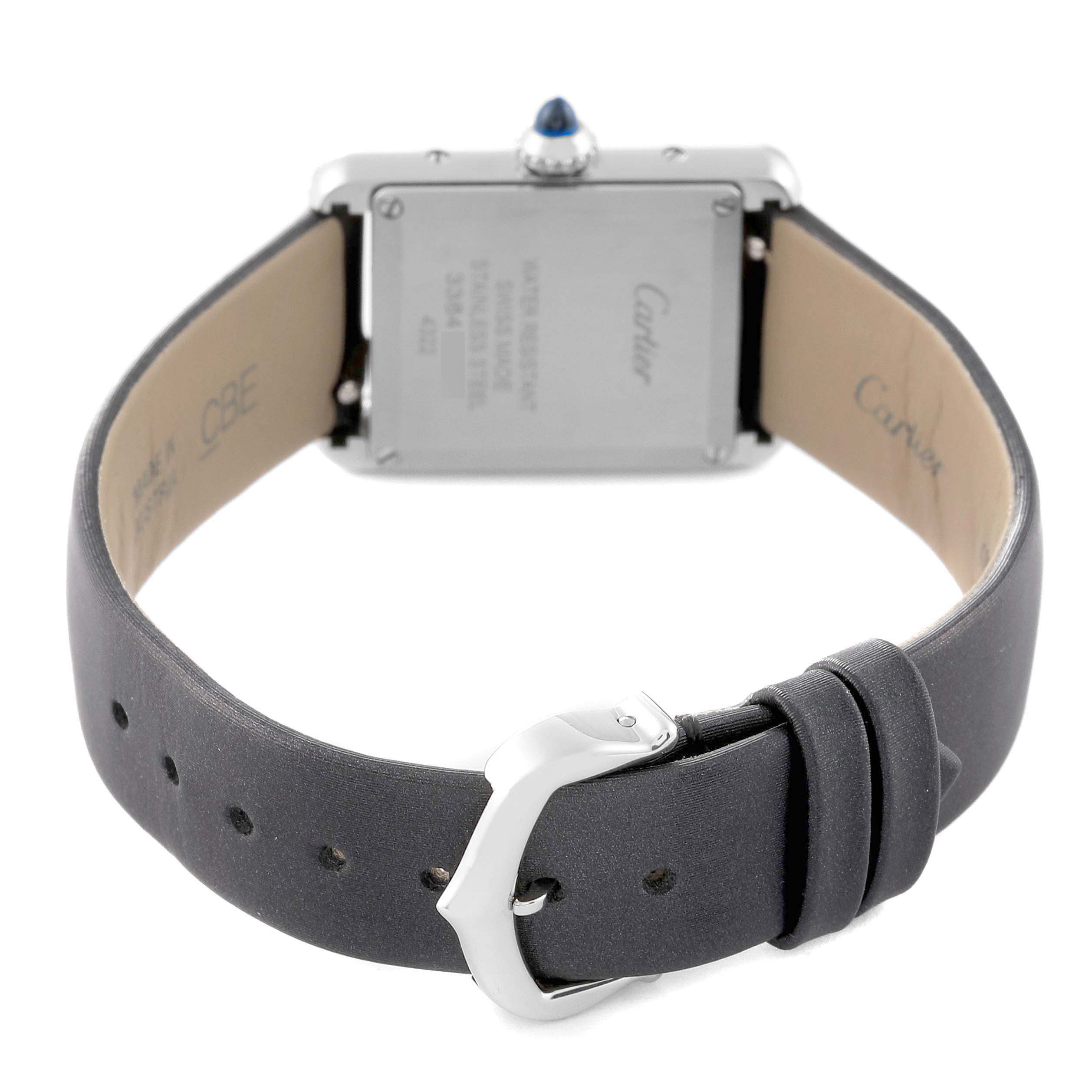 The Cartier Tank Must W4TA0016 Women's Stainless Steel Silver Dial watch is shown from the back, displaying the case, crown, and leather strap with buckle.