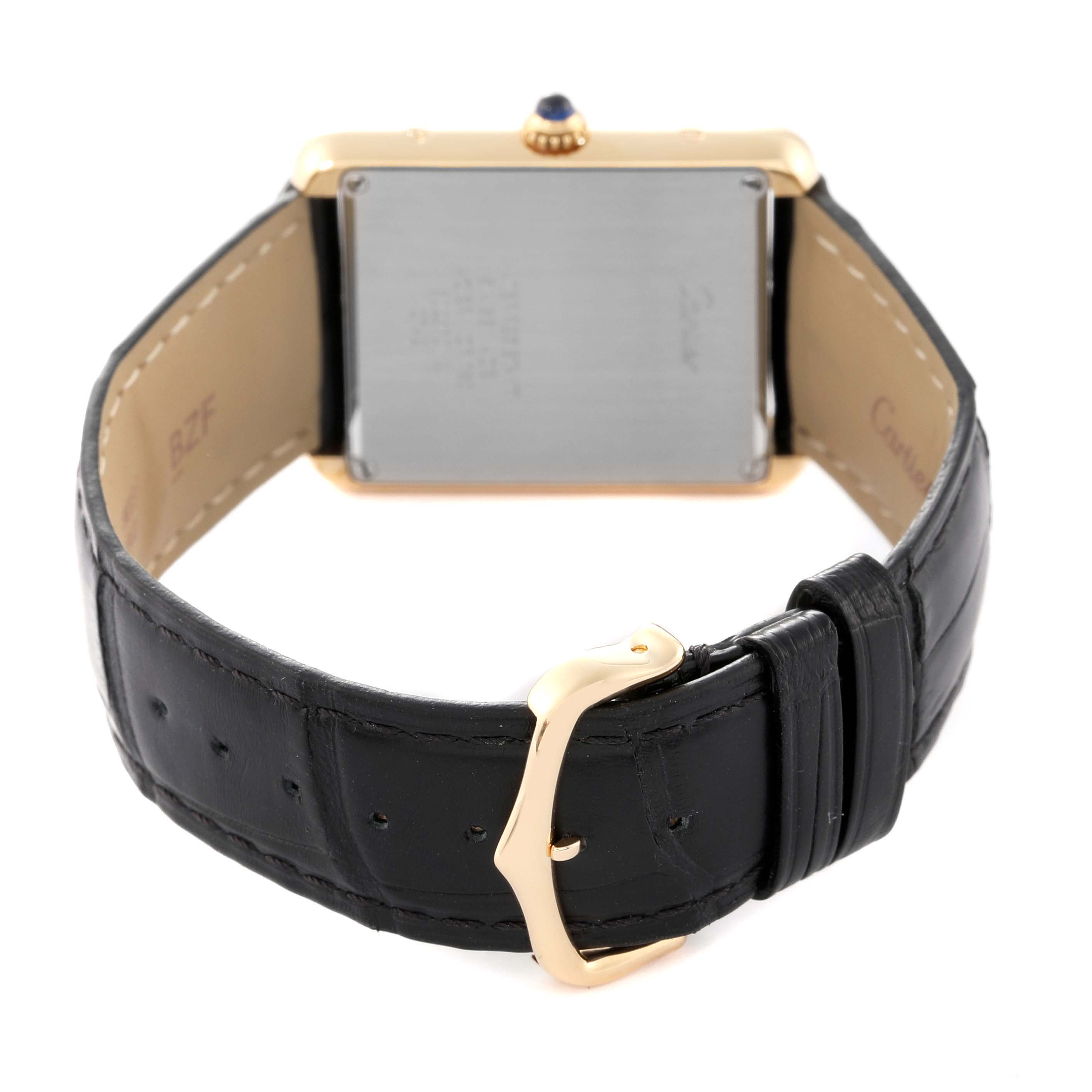 The image shows the back view of a Cartier Tank Solo W1018855 Men's Steel and Gold (two tone) Silver Dial W1018855 Men's Steel and Gold (two tone) Silver Dial watch, focusing on the case back and black leather strap with a gold buckle.