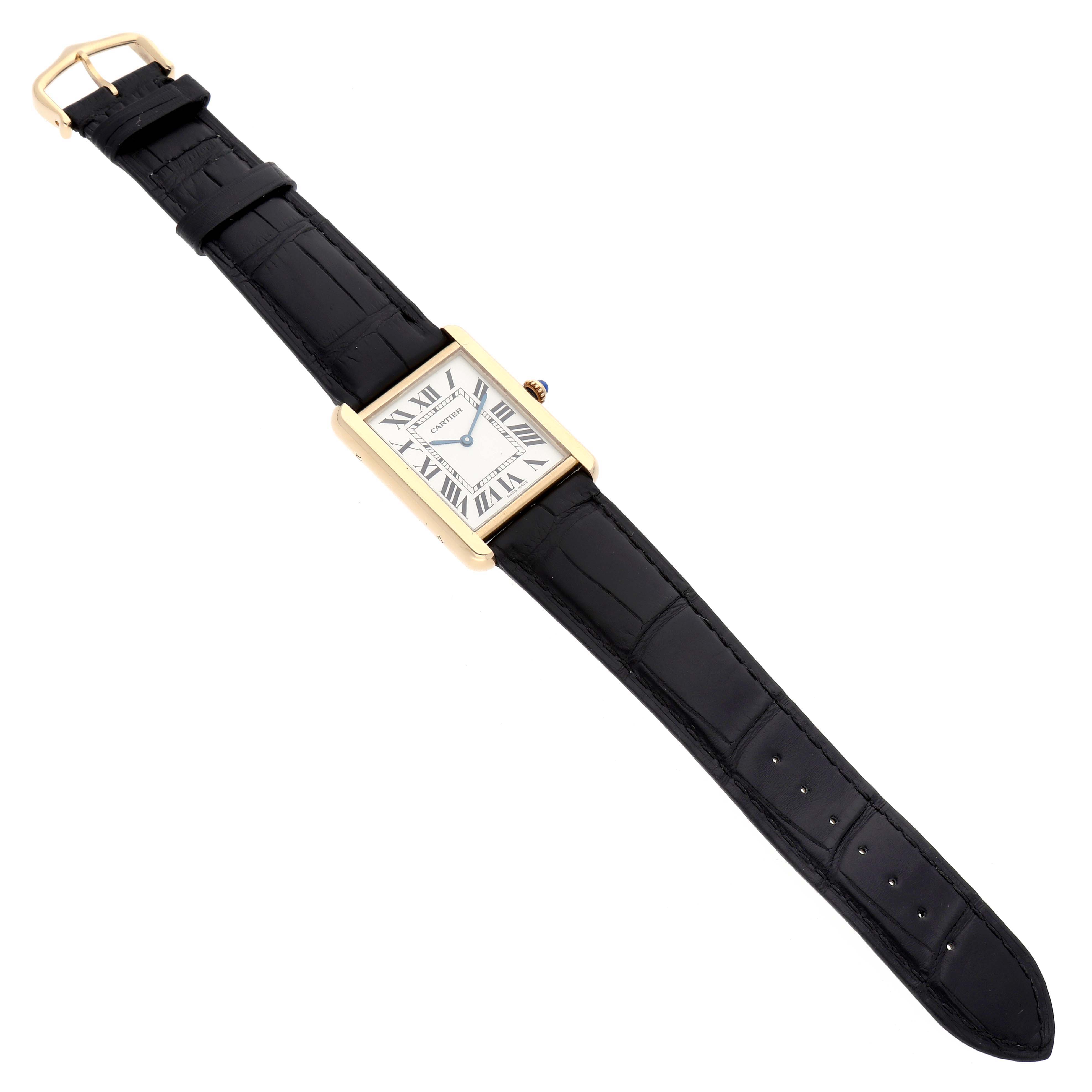 The image shows a top-down view of a Cartier Tank Solo W1018855 Men's Steel and Gold (two tone) Silver Dial W1018855 Men's Steel and Gold (two tone) Silver Dial watch, highlighting the rectangular face, Roman numerals, and black leather strap.