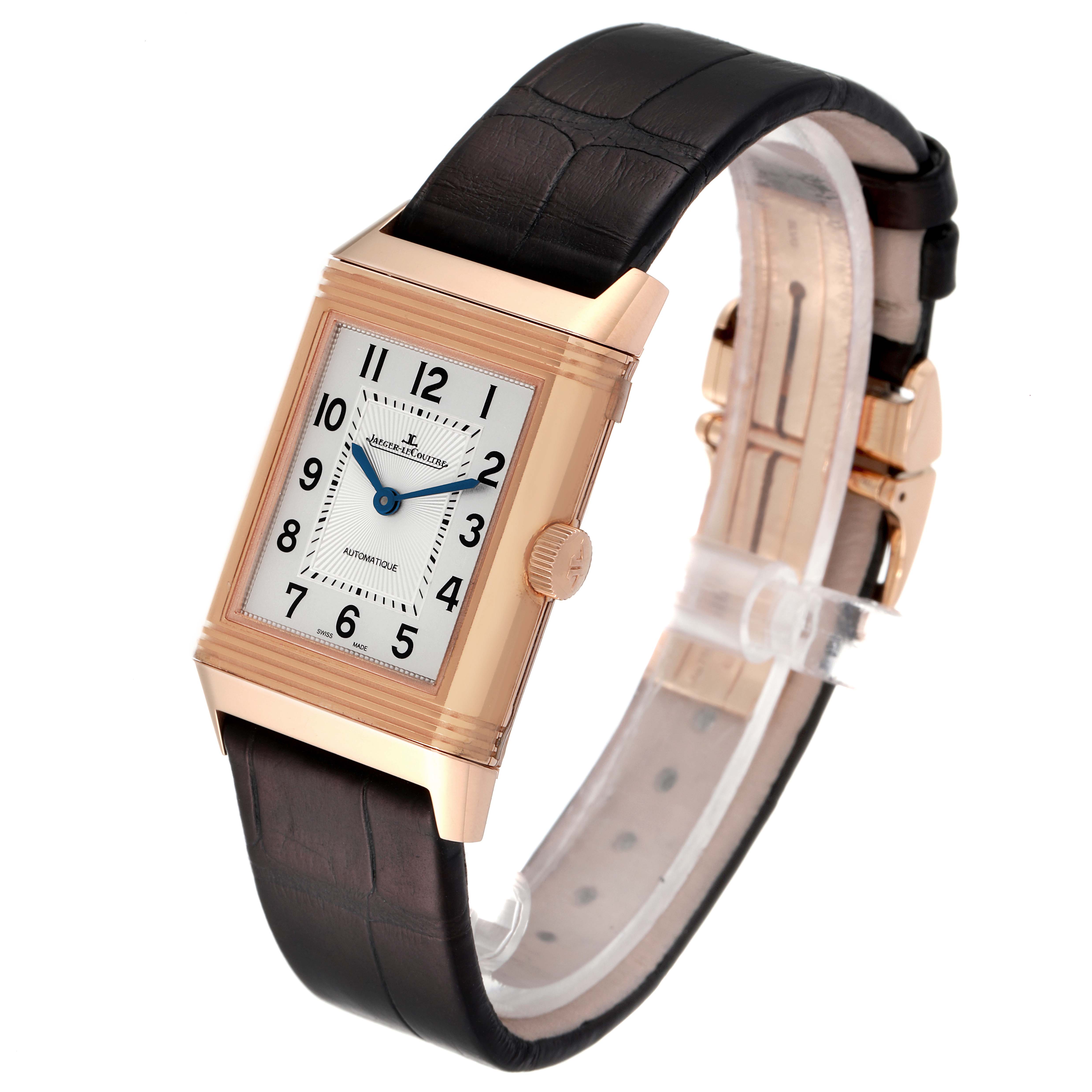 The image shows a Jaeger LeCoultre Reverso Q2572420 Men's Rose Gold Silver Dial Q2572420 Men's Rose Gold Silver Dial watch at an angled side view, highlighting the dial, case, crown, and leather strap.