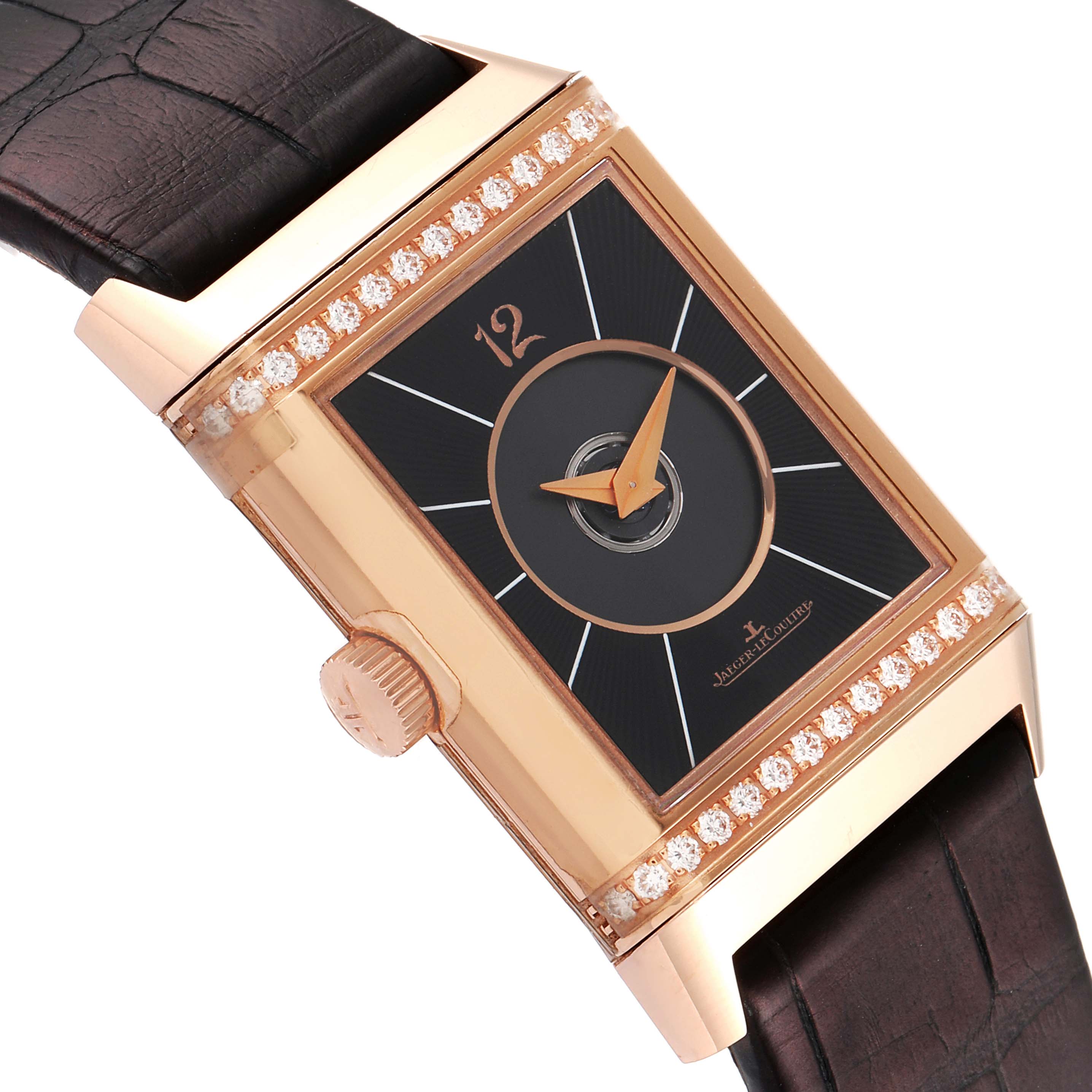 The image shows a close-up angle of the Jaeger LeCoultre Reverso Q2572420 Men's Rose Gold Silver Dial Q2572420 Men's Rose Gold Silver Dial watch showcasing its dial, crown, strap, and diamond-set bezel.