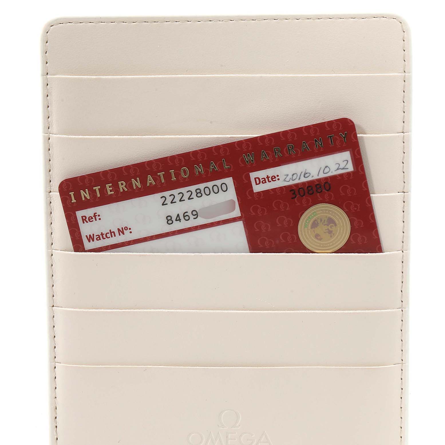 This image shows an International Warranty card for an Omega Seamaster 2222.80.00 Men
s Stainless Steel Blue Dial 2222.80.00 Men
s Stainless Steel Blue Dial watch inserted into a white cardholder.