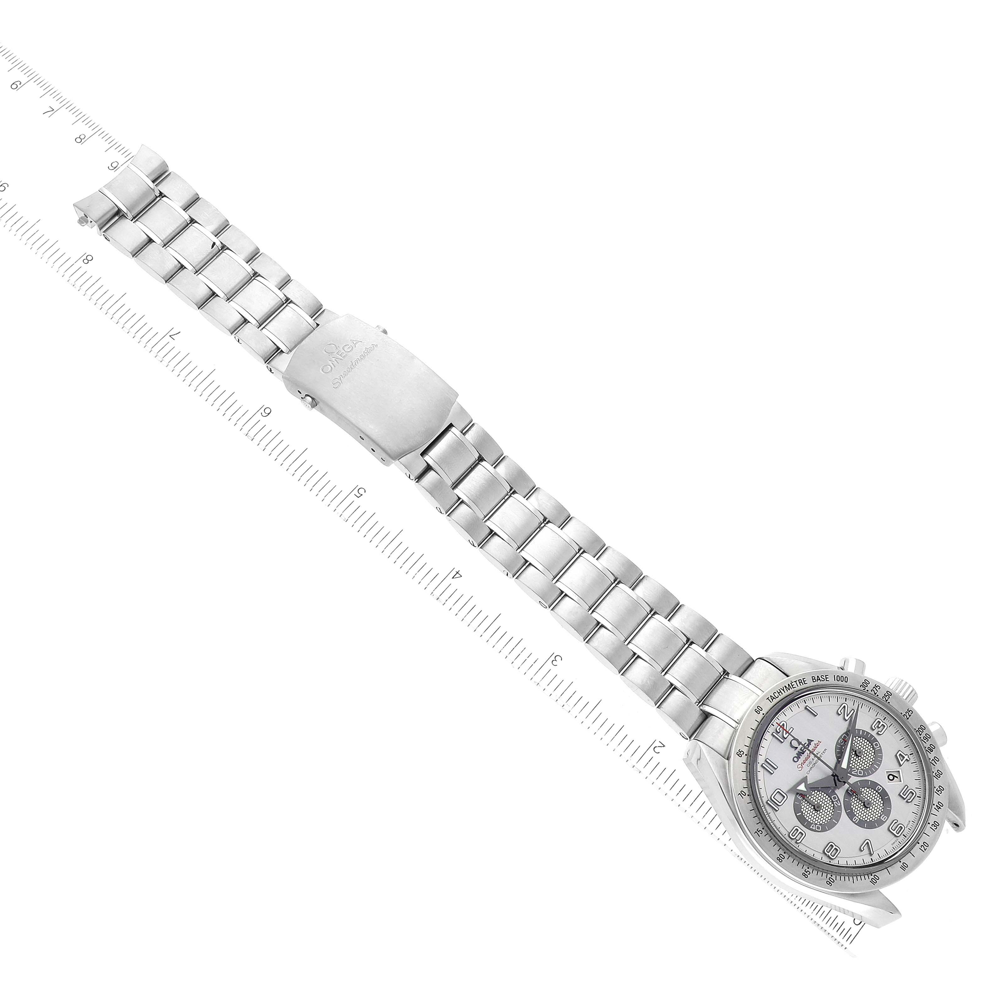 The image shows a top-down view of an Omega Speedmaster 321.10.44.50.02.001 Men
s Stainless Steel Silver Dial 321.10.44.50.02.001 Men
s Stainless Steel Silver Dial watch, highlighting the dial, bracelet, and clasp with a ruler beside it.