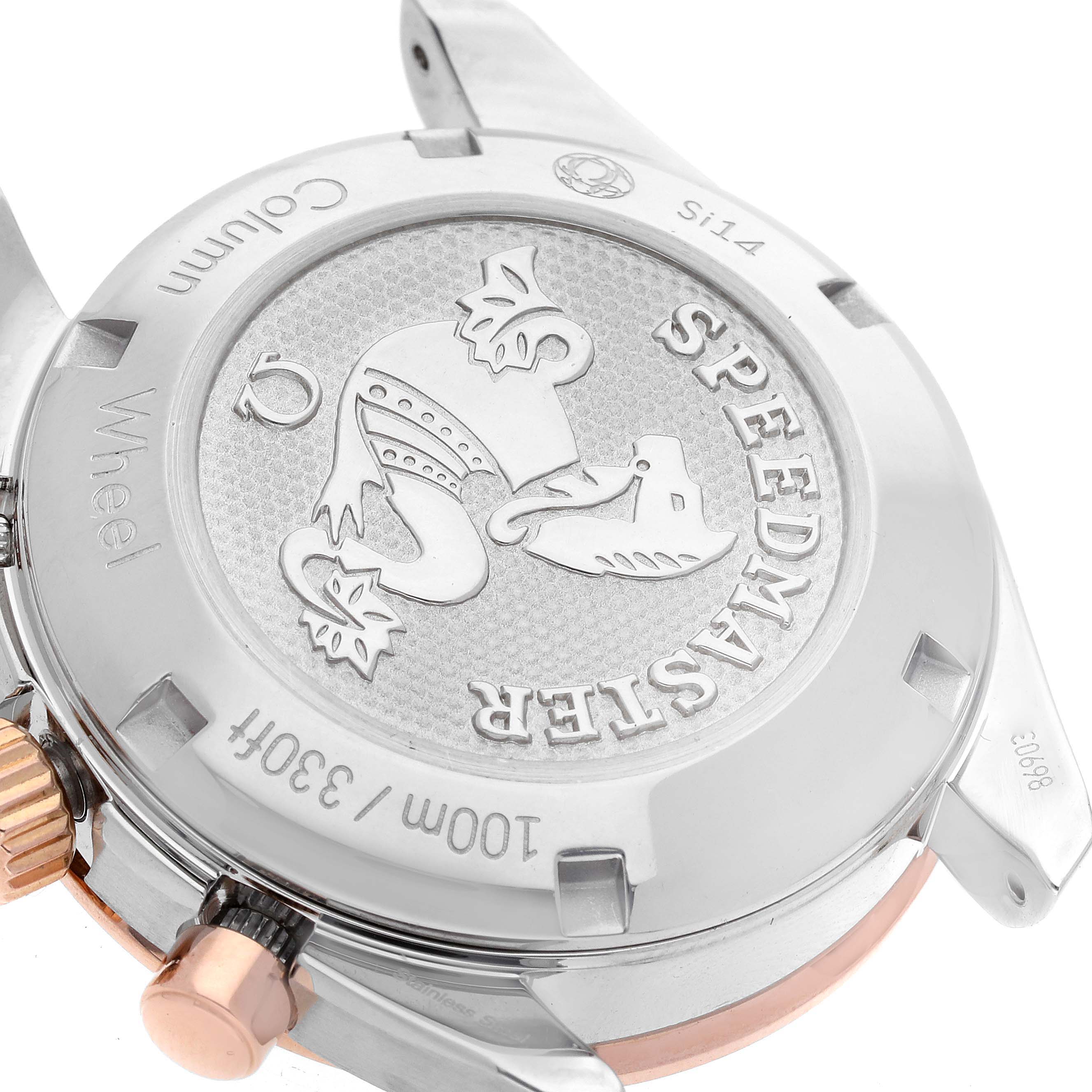 The image shows the back case and crown of an Omega Speedmaster 324.23.38.50.02.002 Men's Steel and Gold (two tone) Silver Dial 324.23.38.50.02.002 Men's Steel and Gold (two tone) Silver Dial watch from an angled close-up view.