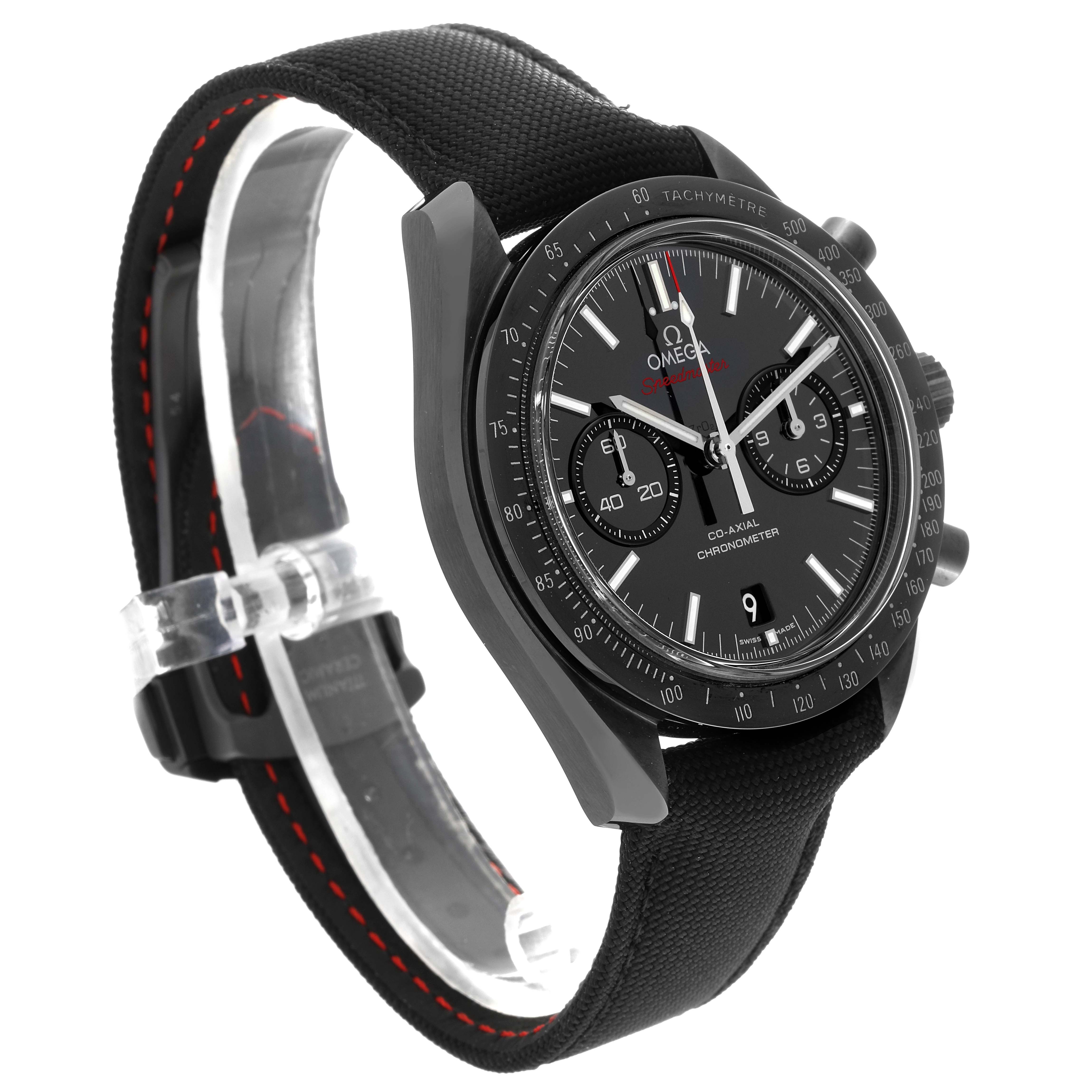 The image shows an angled view of an Omega Speedmaster 311.92.44.51.01.007 Men
s Ceramic Black Dial 311.92.44.51.01.007 Men
s Ceramic Black Dial watch, displaying its face, bezel, and fabric strap with red stitching.