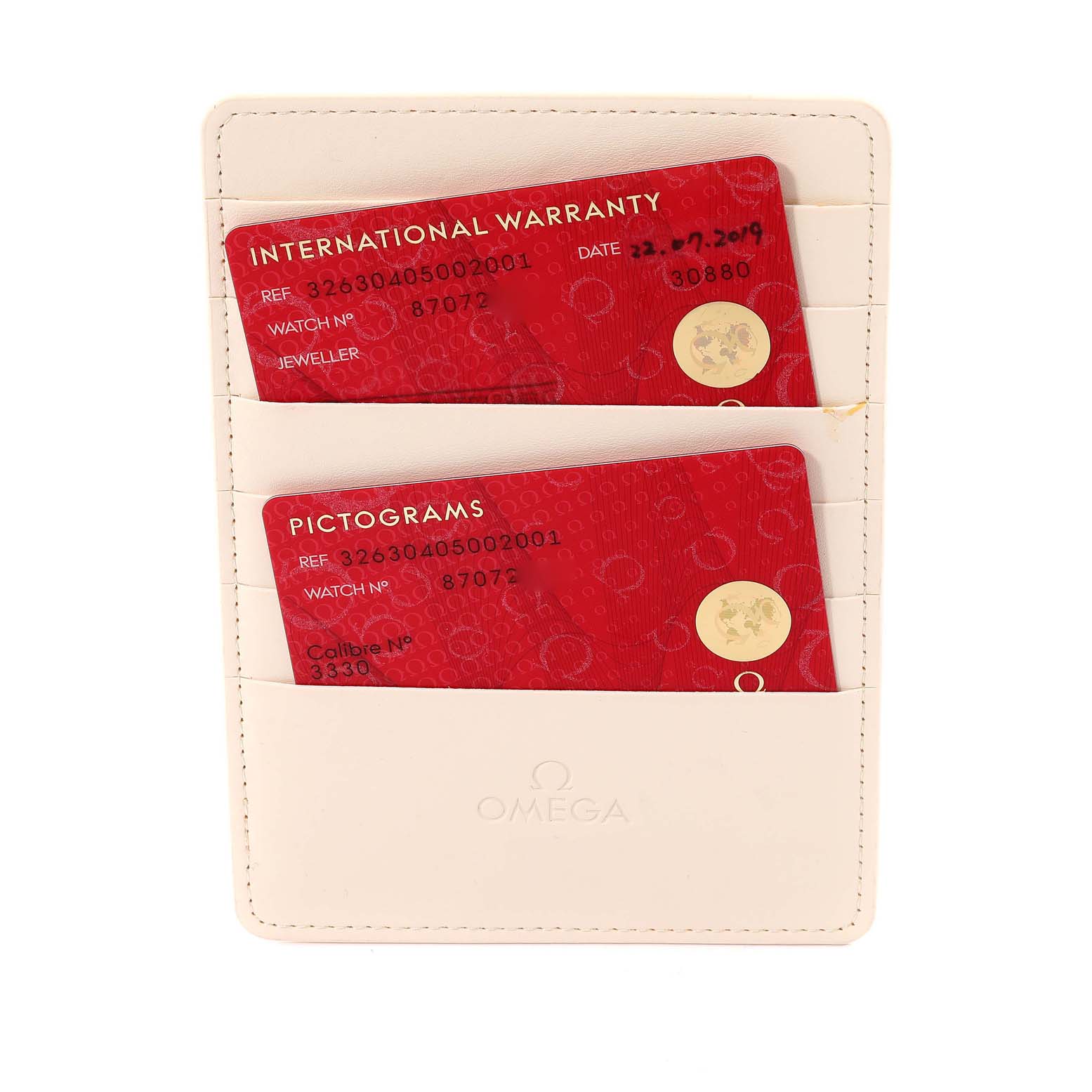 The image shows two red International Warranty and Pictograms cards in a white Omega cardholder, related to the Omega Speedmaster 326.30.40.50.02.001 Men
s Stainless Steel Silver Dial 326.30.40.50.02.001 Men
s Stainless Steel Silver Dial watch.