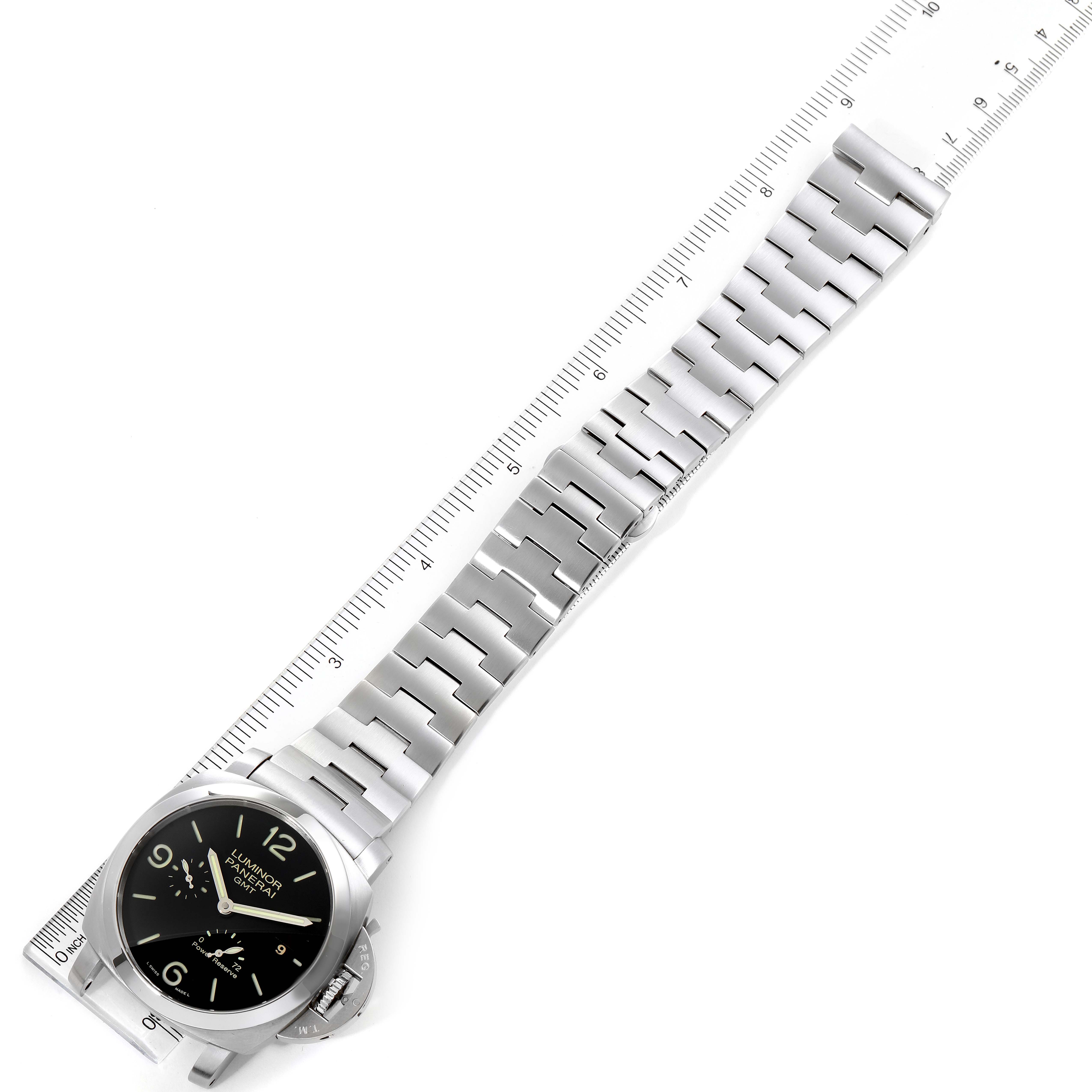 The image shows an overhead view of a Panerai Luminor PAM00347 Men
s Stainless Steel Black Dial PAM00347 Men
s Stainless Steel Black Dial watch, including its face and metal bracelet along with a ruler for scale.