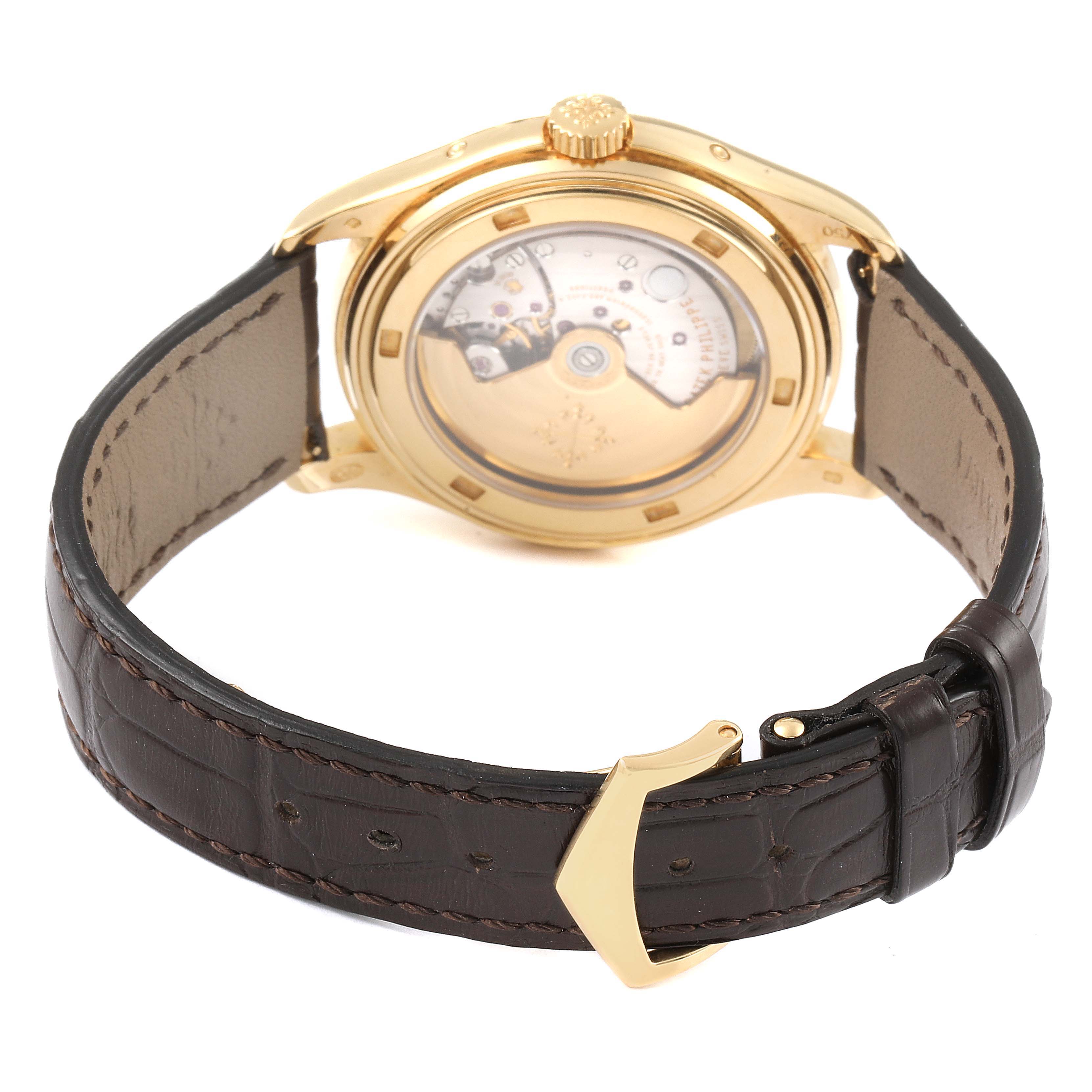 The image shows the rear view of the Patek Philippe 5146J - 01D Men
s Yellow Gold Grey Dial 5146J - 01D Men
s Yellow Gold Grey Dial Complicated Annual Calendar Yellow Gold Mens Watch 5146, highlighting the leather strap and transparent case back.