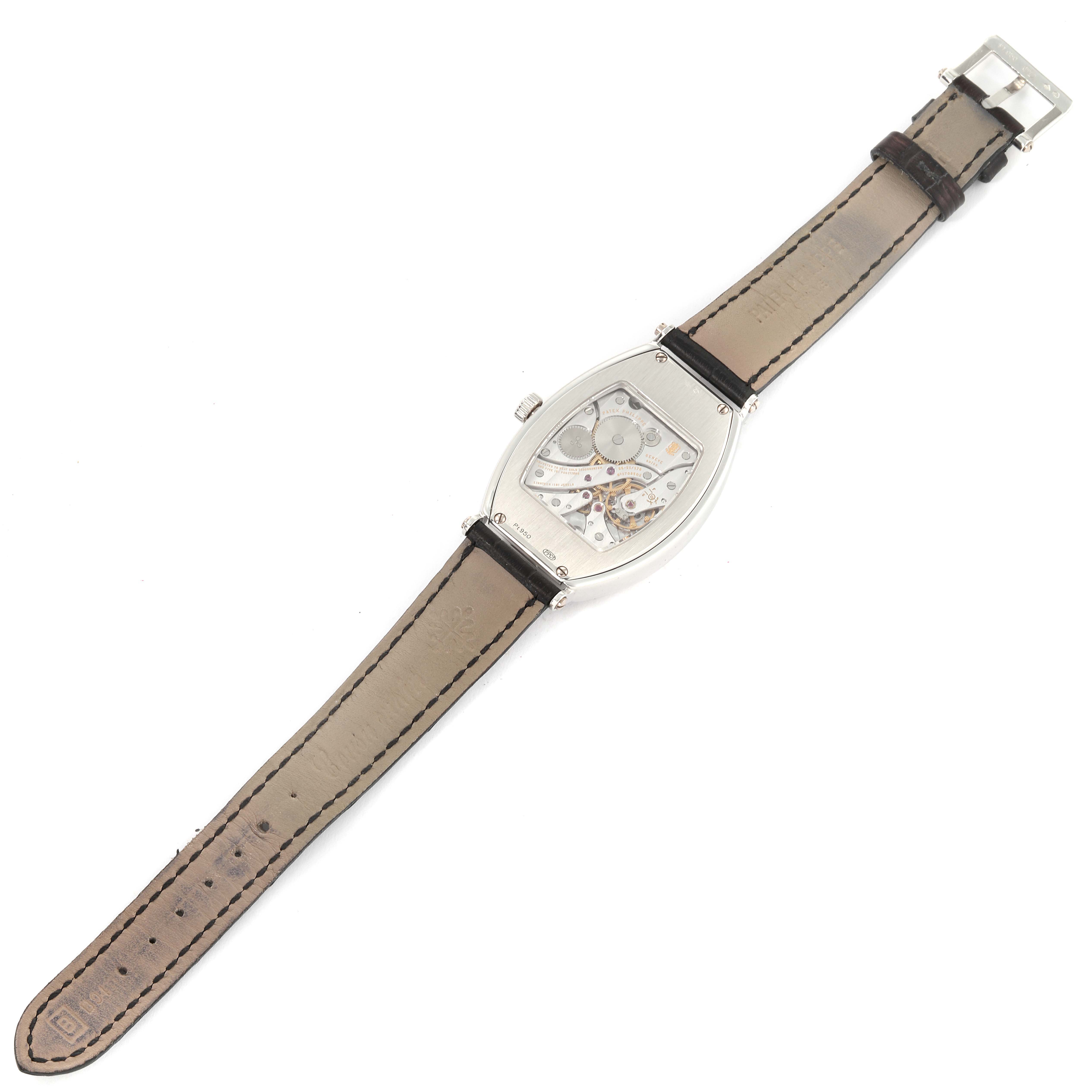 The image shows the back view of a Patek Philippe Gondolo 5098P Men's Platinum Silver Dial 5098P Men's Platinum Silver Dial watch, displaying its internal mechanism and full leather strap.