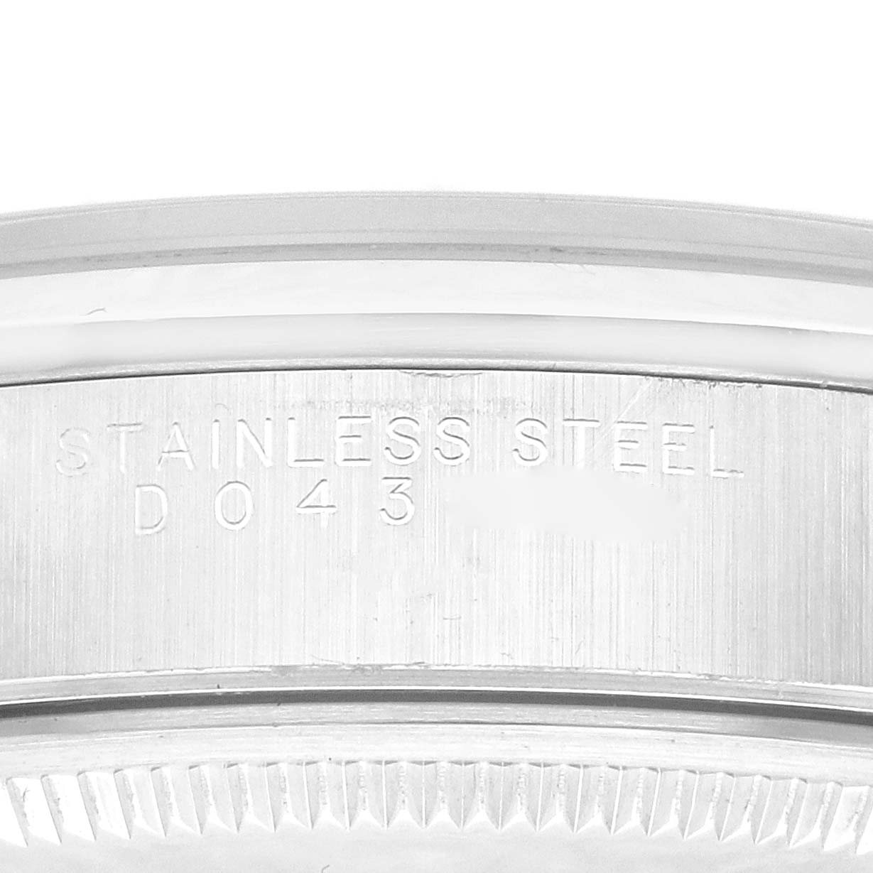 This is a close-up of the case back and edge of a stainless steel Rolex Air-King 14000M Men's Stainless Steel Black Dial 14000M Men's Stainless Steel Black Dial watch, showing part of its inscription.