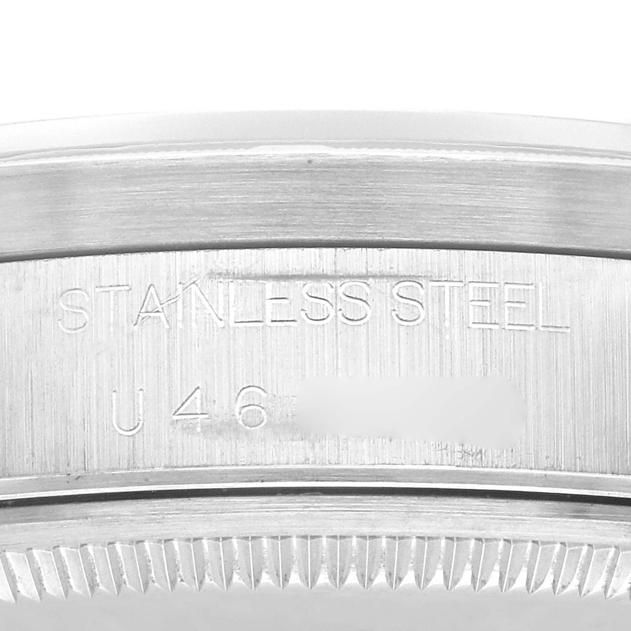 This image shows a close-up angle of the serial and material engravings on the stainless steel casing of a Rolex Air-King 14010 Men's Stainless Steel Blue Dial 14010 Men's Stainless Steel Blue Dial watch.