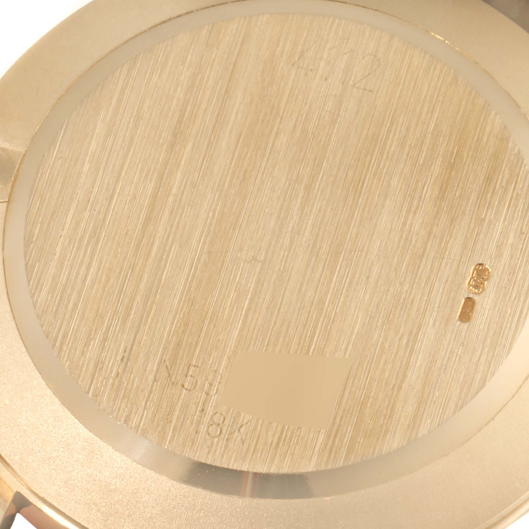 This image shows the back case of a Rolex Cellini 4112 Men's Yellow Gold White Dial 4112 Men's Yellow Gold White Dial watch at a close-up angle.