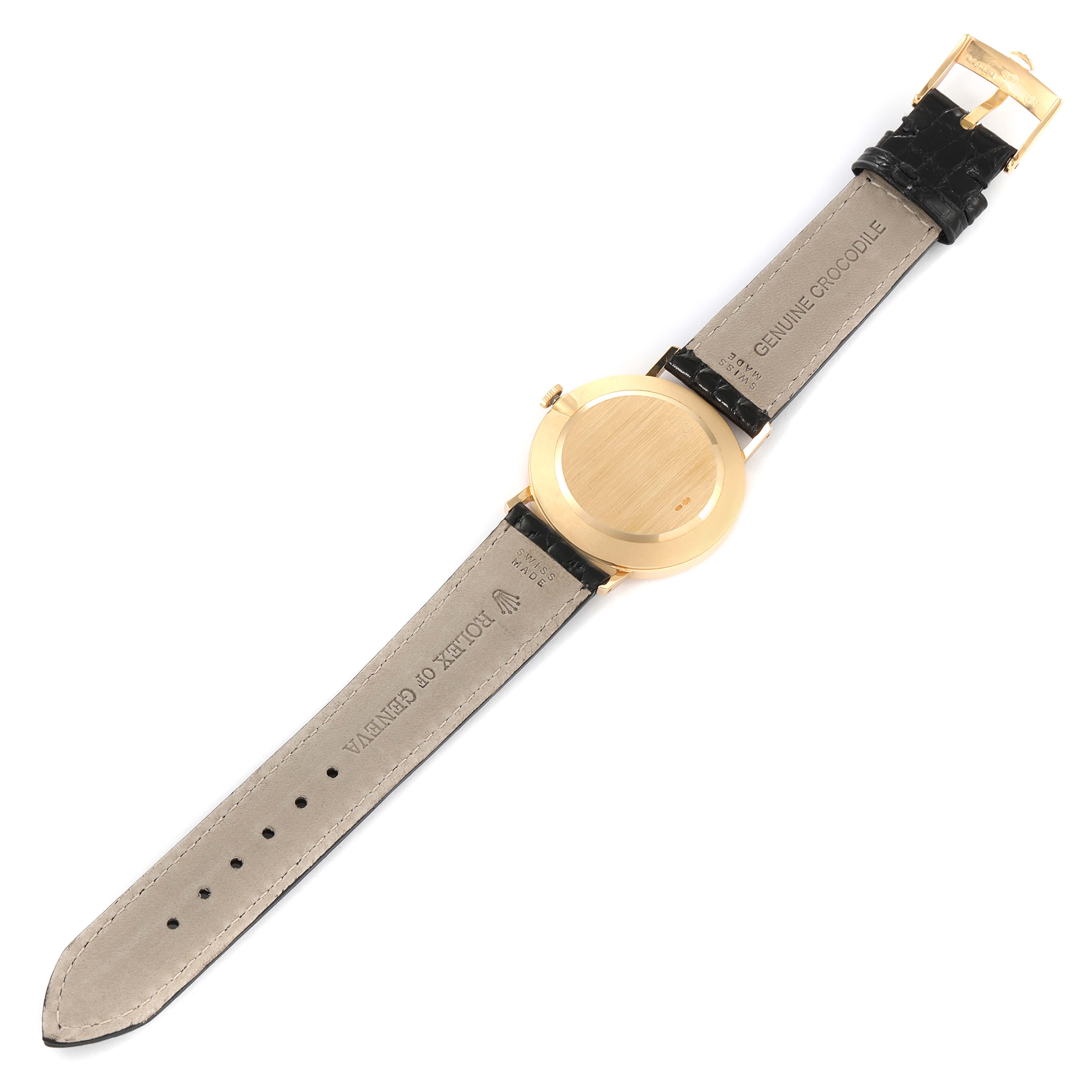 This image shows the back view of a Rolex Cellini 4112 Men's Yellow Gold White Dial 4112 Men's Yellow Gold White Dial watch, displaying its case and leather strap with a buckle.