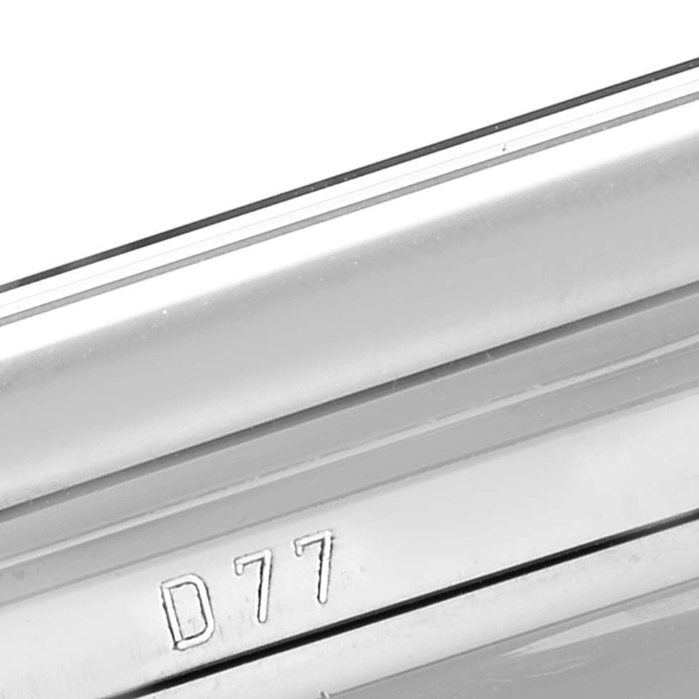 This close-up image shows part of the casing including the edge and markings of a Rolex Cellini 5443/9 Men
s White Gold Black Dial 5443/9 Men
s White Gold Black Dial watch with "D77" engraved.