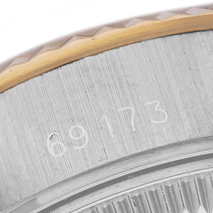 The image shows an engraved serial number on the case back of a Rolex Datejust 69173 Women's Steel and Gold (two tone) Champagne Dial 69173 Women's Steel and Gold (two tone) Champagne Dial watch model, viewed in close-up.