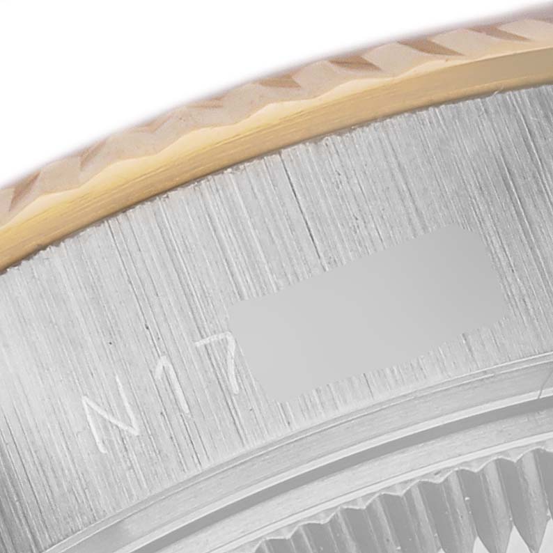 This close-up image shows the engraved bezel with a serial number of a Rolex Datejust 69173 Women's Steel and Gold (two tone) Champagne Dial 69173 Women's Steel and Gold (two tone) Champagne Dial watch.