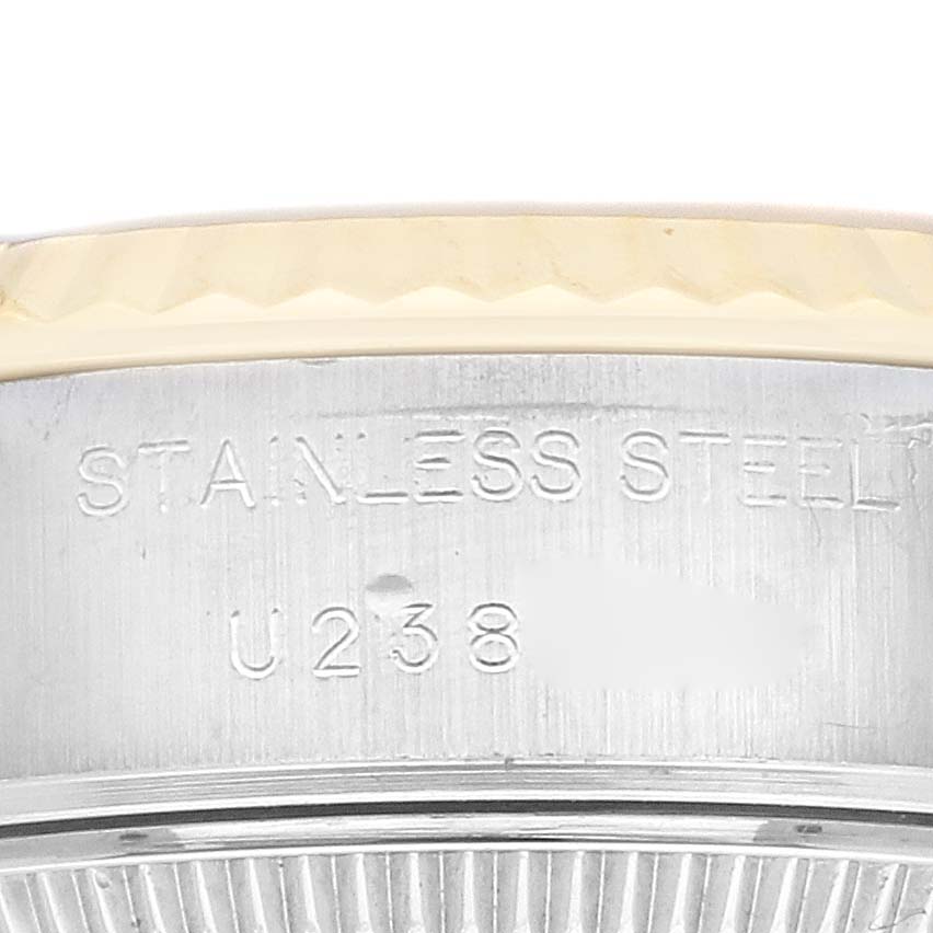 This image shows a close-up of the side of a Rolex Datejust 69173 Women's Steel and Gold (two tone) Champagne Dial 69173 Women's Steel and Gold (two tone) Champagne Dial watch case, highlighting the "STAINLESS STEEL" engraving.