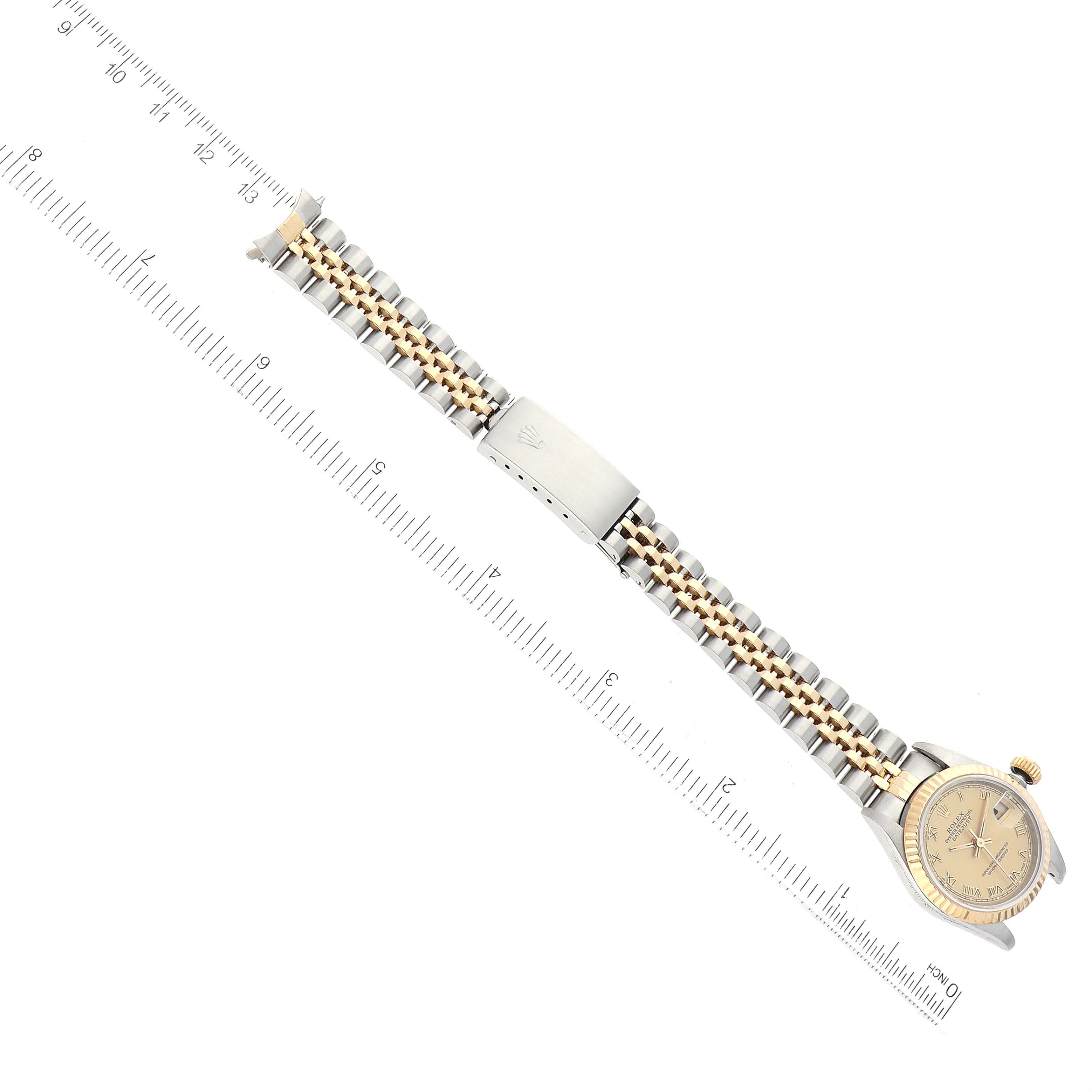 The image shows a Rolex Datejust 69173 Women's Steel and Gold (two tone) Champagne Dial 69173 Women's Steel and Gold (two tone) Champagne Dial watch placed flat with its bracelet fully extended alongside a ruler for scale.