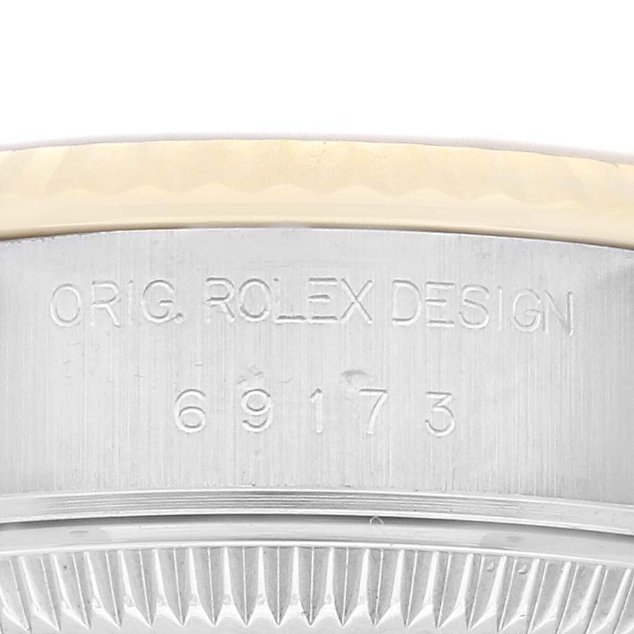 This image shows a close-up of the casing and reference number of the Rolex Datejust 69173 Women's Steel and Gold (two tone) Champagne Dial 69173 Women's Steel and Gold (two tone) Champagne Dial, displaying "ORIG. ROLEX DESIGN 69173."