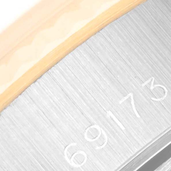 This close-up image of a Rolex Datejust 69173 Women's Steel and Gold (two tone) Champagne Dial 69173 Women's Steel and Gold (two tone) Champagne Dial watch shows the model number engraved on its case side.