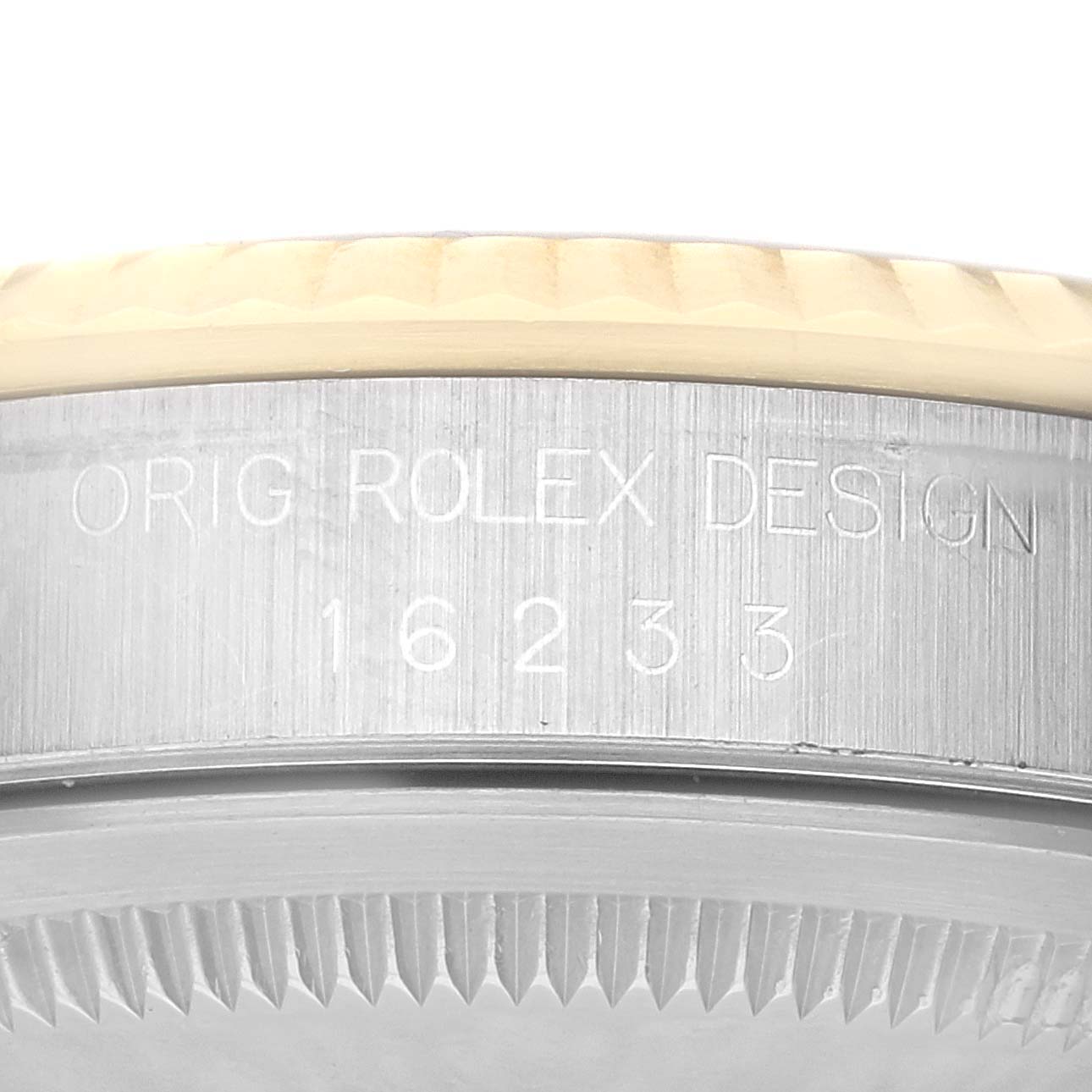 The image shows a close-up of the case side of a Rolex Datejust 16233 Men's Steel and Gold (two tone) Champagne Dial 16233 Men's Steel and Gold (two tone) Champagne Dial watch, highlighting the engraved model number "16233".