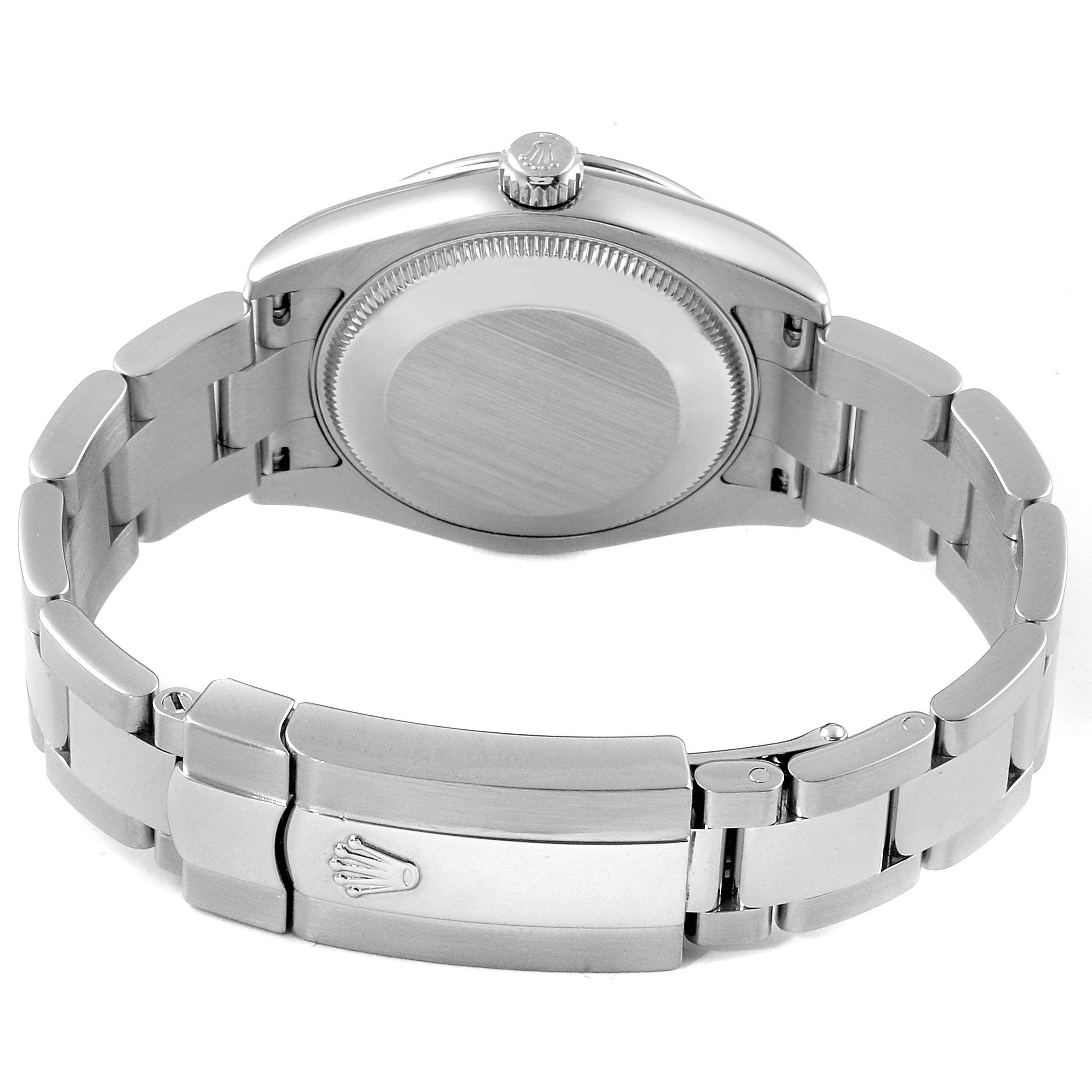The image shows the back view of a Mid-Size Rolex watch, highlighting the case back and bracelet with the clasp.