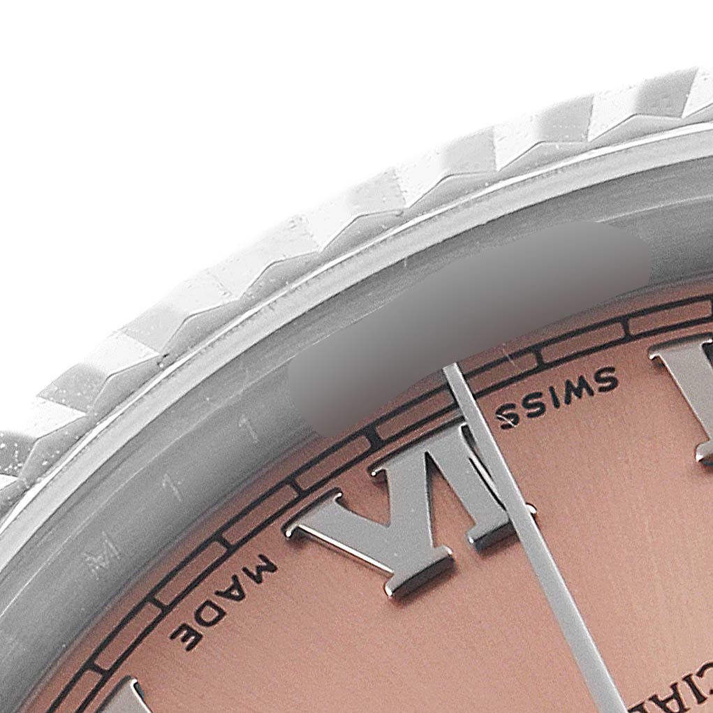 This image shows a close-up of the dial, bezel, and part of the minute hand of a Rolex Mid-Size 178274 Women's Stainless Steel Pink Dial 178274 Women's Stainless Steel Pink Dial watch.