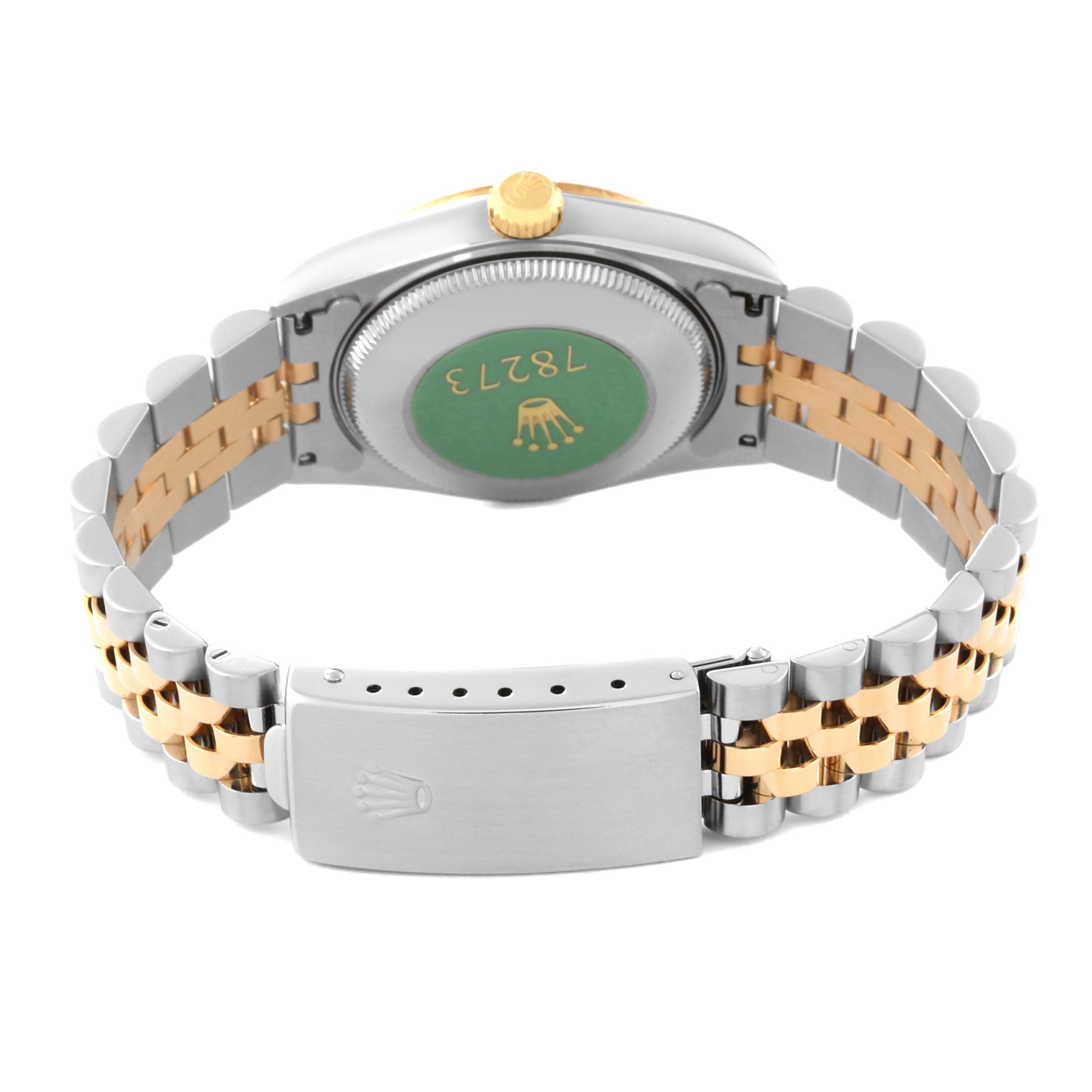The image shows the back view of a mid-size Rolex watch, highlighting its case back, the two-tone bracelet, and the clasp.