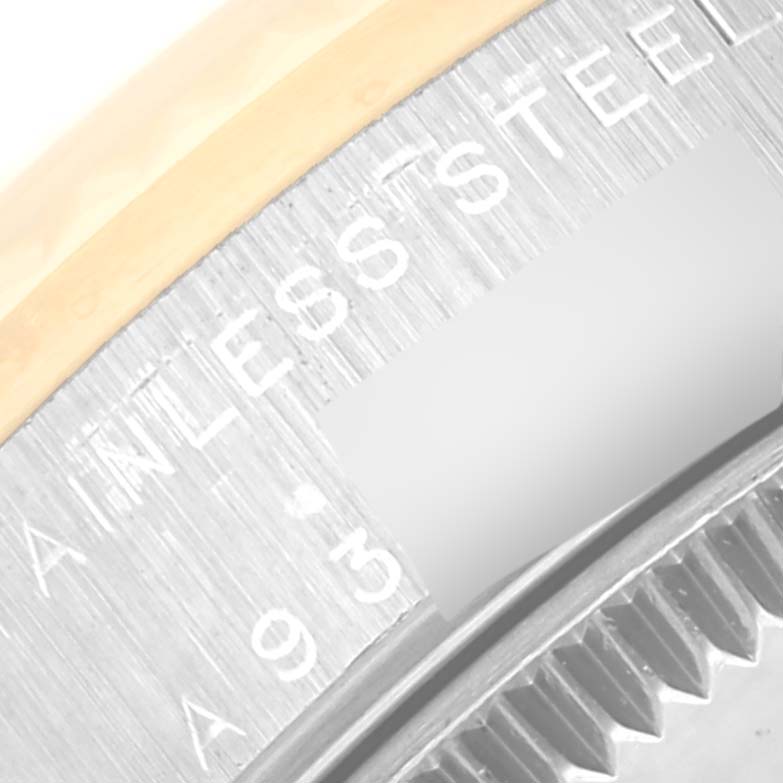 The image shows a close-up of the side engraving and the edge of the bezel of a Rolex Mid-Size 78273 Women
s Steel and Gold (two tone) Silver Dial 78273 Women
s Steel and Gold (two tone) Silver Dial model watch.