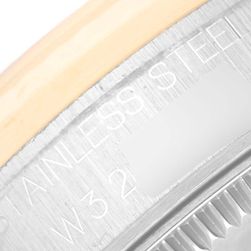 The image shows a close-up of the outer edge and part of the case back of a Mid-Size Rolex watch, focusing on the engraved text.