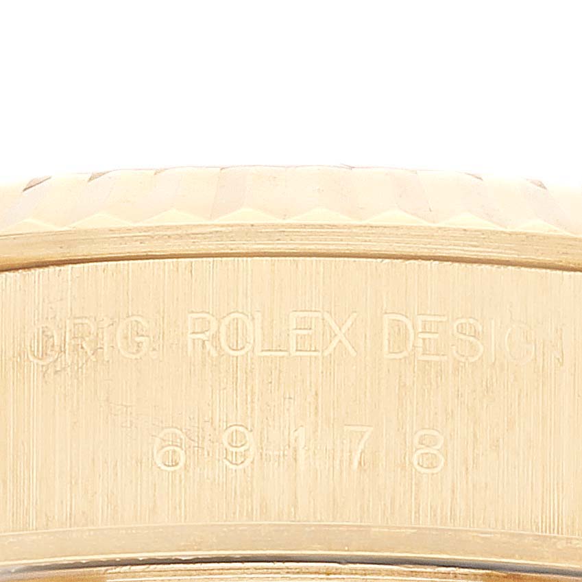 The image shows an up-close side view of the case back of the Rolex President 69178 Women
s Yellow Gold Champagne Dial 69178 Women
s Yellow Gold Champagne Dial model, displaying its engraved details.