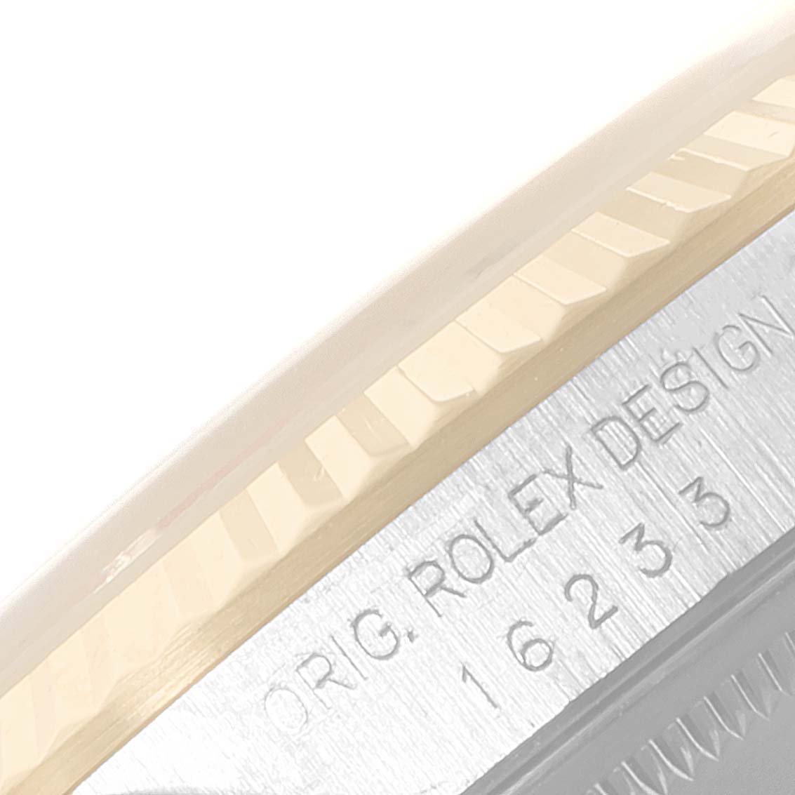 This close-up image shows the engraved details and fluted bezel of a Rolex Datejust 16233 Men's Steel and Gold (two tone) Blue Dial 16233 Men's Steel and Gold (two tone) Blue Dial watch.