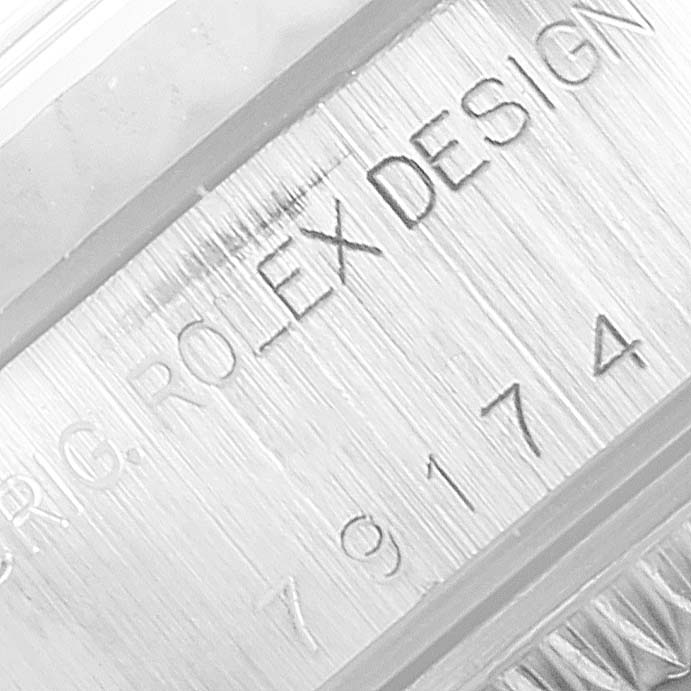 The image shows a close-up of the engraved details on the case side of a Rolex Datejust 79174 Women's Stainless Steel Black Dial 79174 Women's Stainless Steel Black Dial watch.