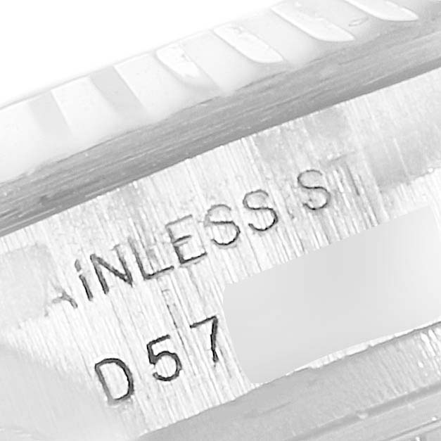 The image shows a close-up of the side of a Rolex Datejust 179174 Women's Stainless Steel Mother of Pearl Dial 179174 Women's Stainless Steel Mother of Pearl Dial watch, featuring part of the fluted bezel and "STAINLESS STEEL" engraving.