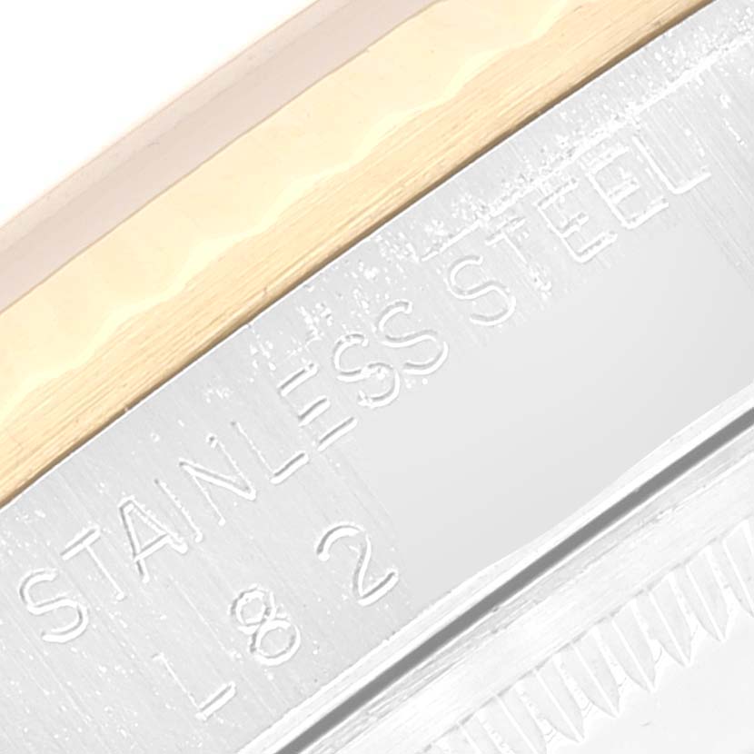 The image shows a close-up of the bezel and case edge of the Rolex Datejust 16233 Men's Steel and Gold (two tone) Beige Dial 16233 Men's Steel and Gold (two tone) Beige Dial, highlighting "STAINLESS STEEL" engraving.