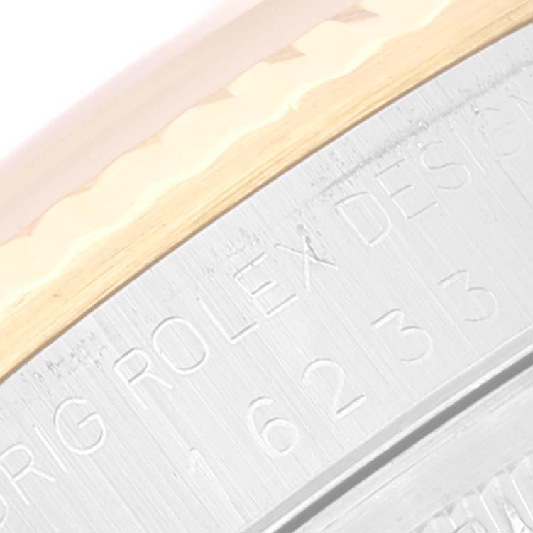 This close-up image shows the engraved side of the bezel and case of a Rolex Datejust 16233 Men's Steel and Gold (two tone) Beige Dial 16233 Men's Steel and Gold (two tone) Beige Dial watch.