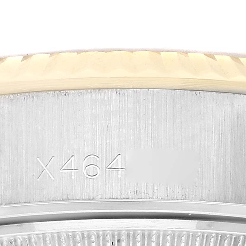 This image shows a close-up of the serial number engraved on the side of the case of a Rolex Datejust 69173 Women's Steel and Gold (two tone) White Dial 69173 Women's Steel and Gold (two tone) White Dial watch.