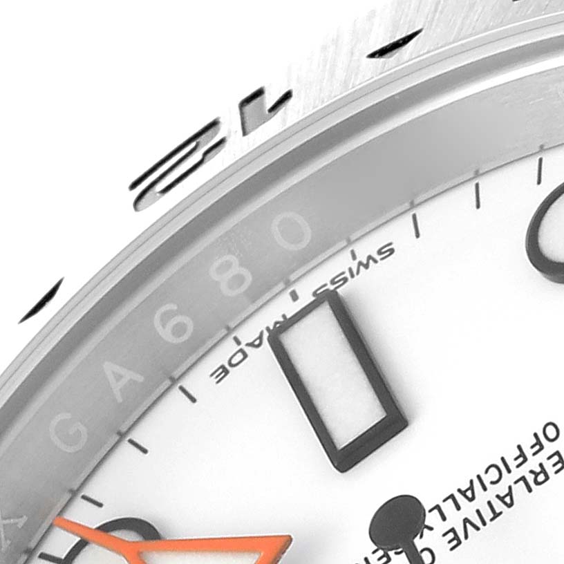 The image shows a close-up of the dial and bezel of a Rolex Explorer 216570 Men
s Stainless Steel White Dial 216570 Men
s Stainless Steel White Dial watch, highlighting the markers and part of the text "Swiss Made."