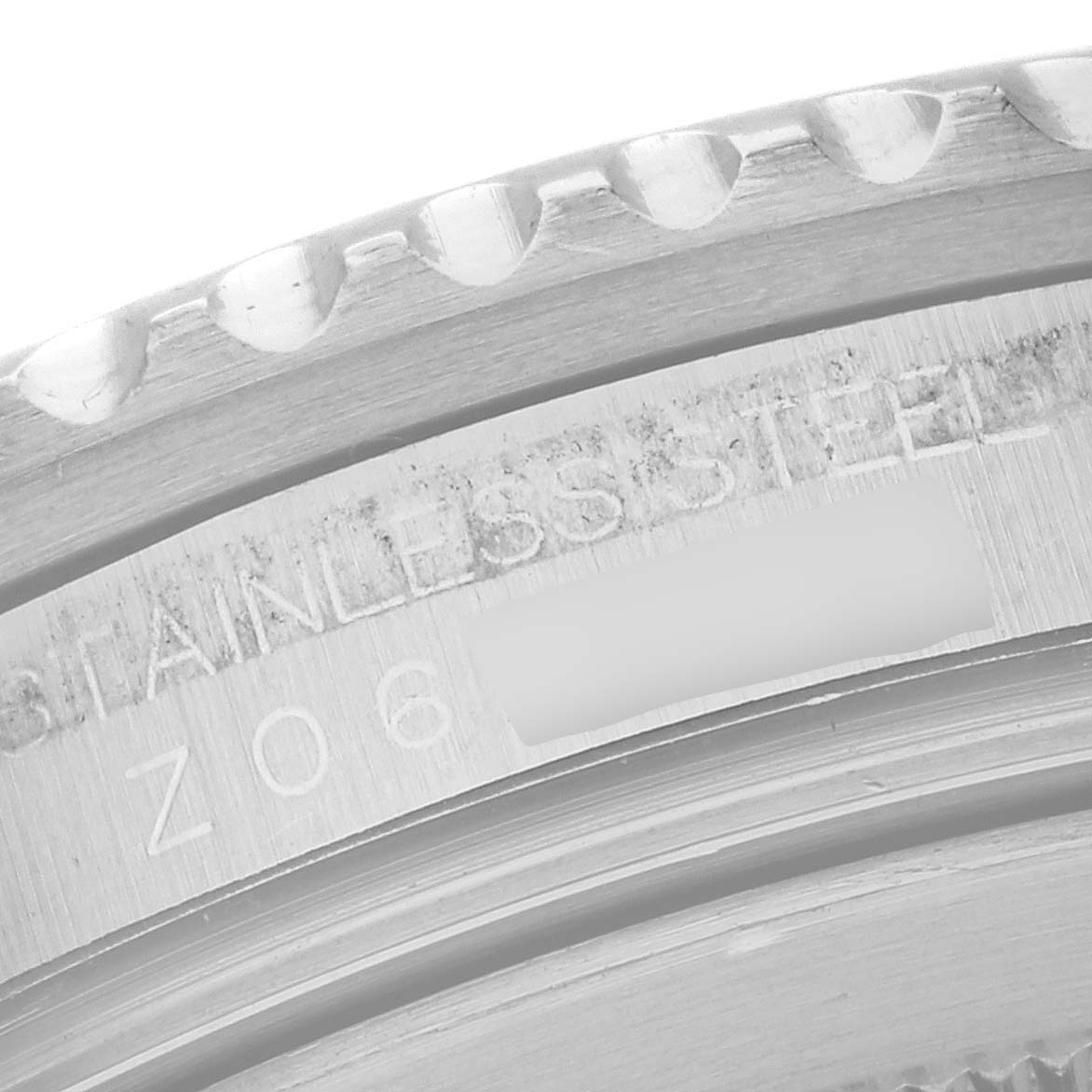 This is a close-up image of the case edge and engraved serial number of a Rolex GMT-Master 16710 Men's Stainless Steel Black Dial 16710 Men's Stainless Steel Black Dial watch.