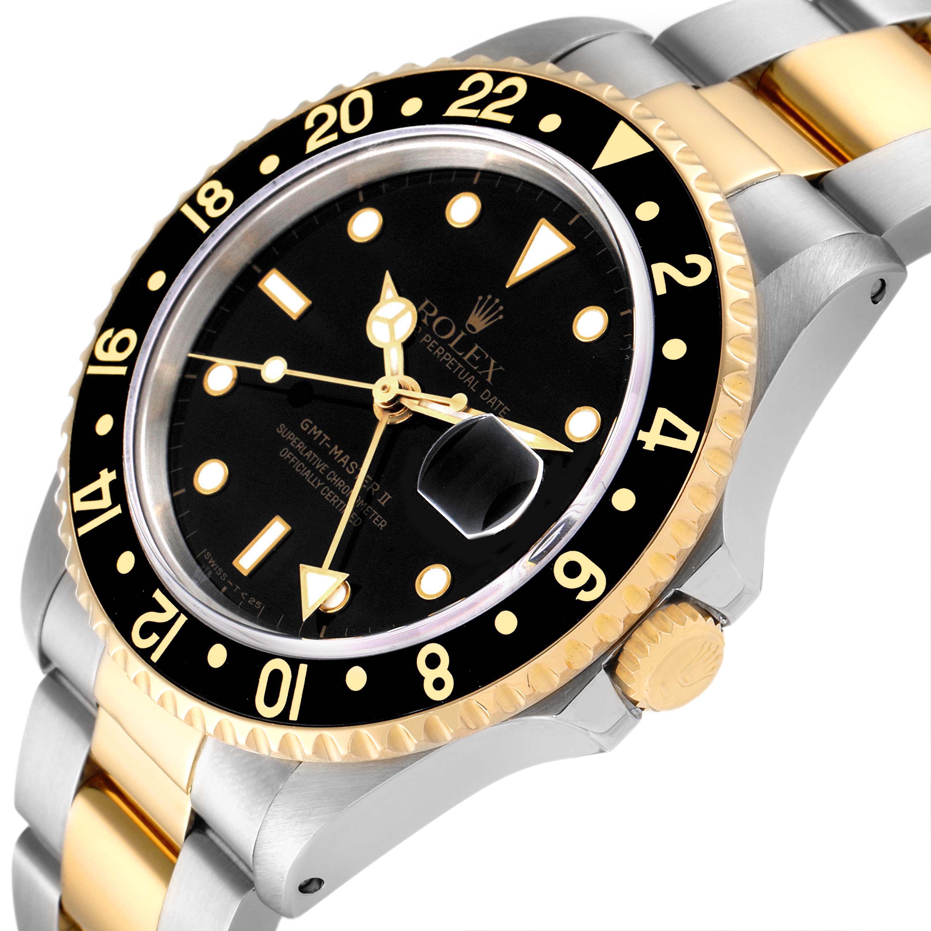 The image shows a Rolex GMT-Master 16713 Men's Steel and Gold (two tone) Black Dial 16713 Men's Steel and Gold (two tone) Black Dial watch angled from the front-left, displaying the bezel, dial, crown, and part of the bracelet.