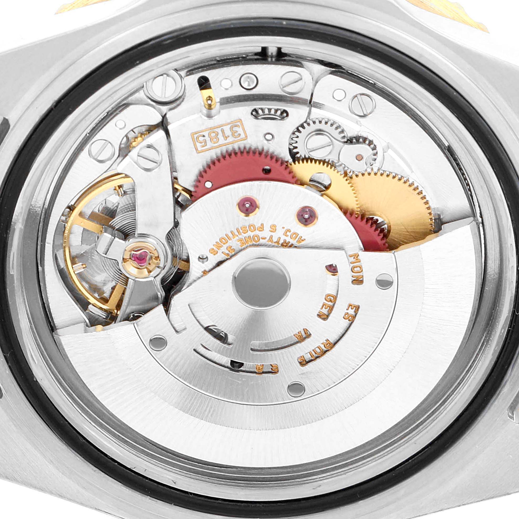 This image shows a close-up of the movement mechanism inside the Rolex GMT-Master 16713 Men's Steel and Gold (two tone) Black Dial 16713 Men's Steel and Gold (two tone) Black Dial watch, revealing its intricate inner components.