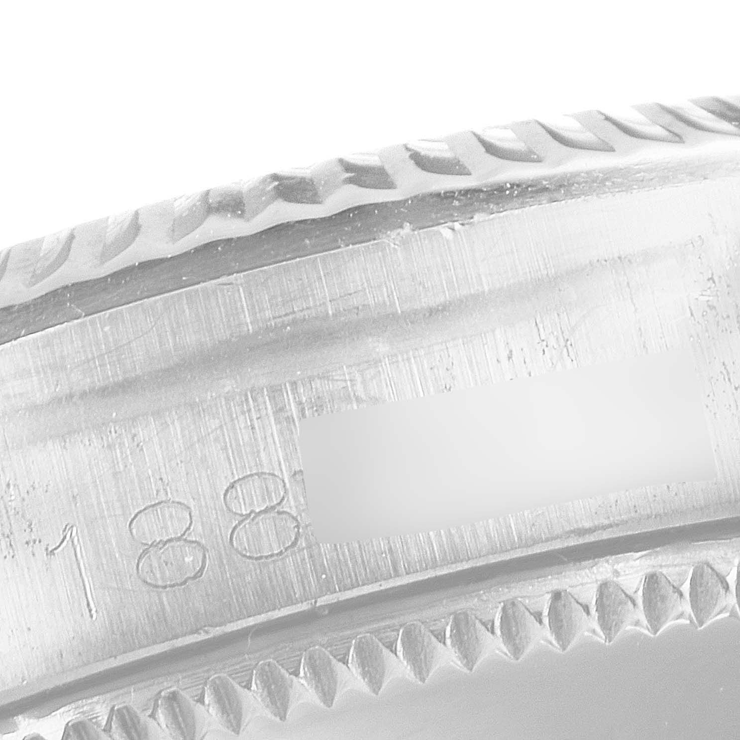 The image shows a close-up angle of the serial number engraving on the case of a Rolex Oyster Perpetual 6619 Women's Stainless Steel Silver Dial 6619 Women's Stainless Steel Silver Dial watch.