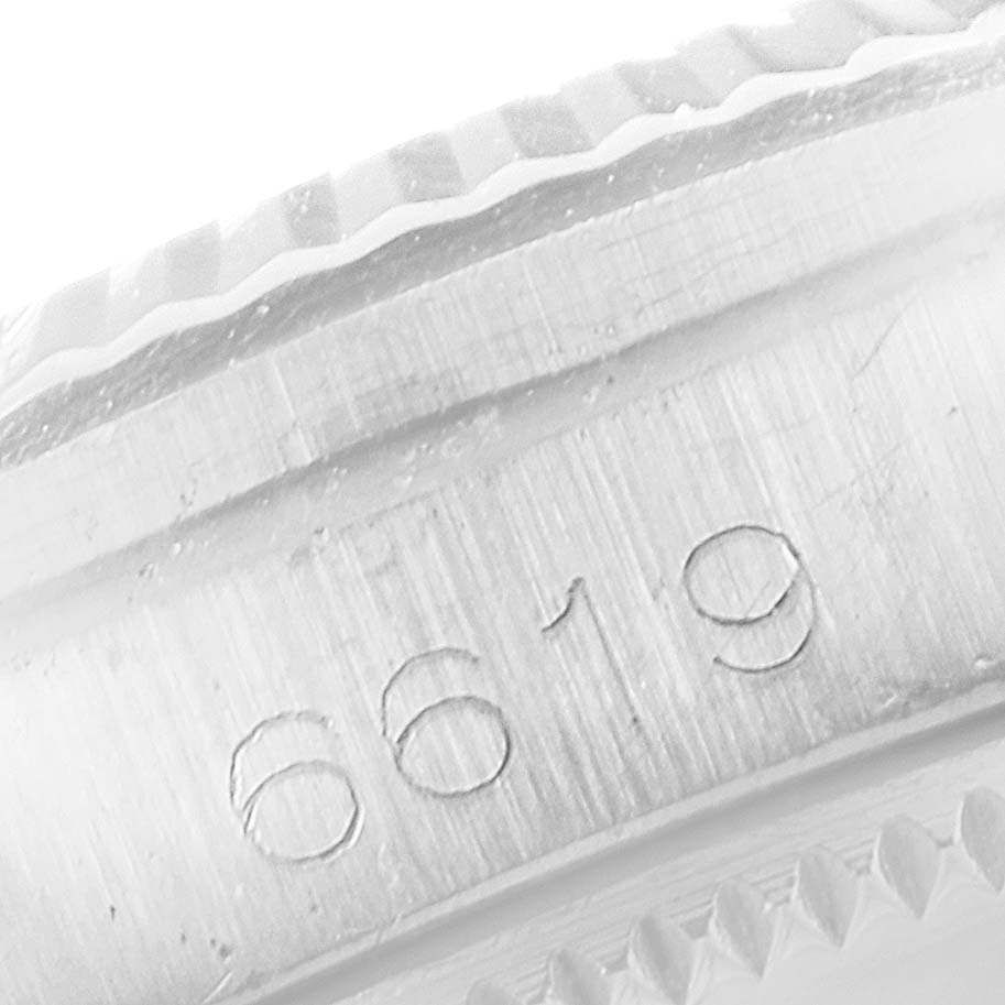 This close-up image shows the serial number engraved on the edge of the case and bezel of a Rolex Oyster Perpetual 6619 Women's Stainless Steel Silver Dial 6619 Women's Stainless Steel Silver Dial watch.