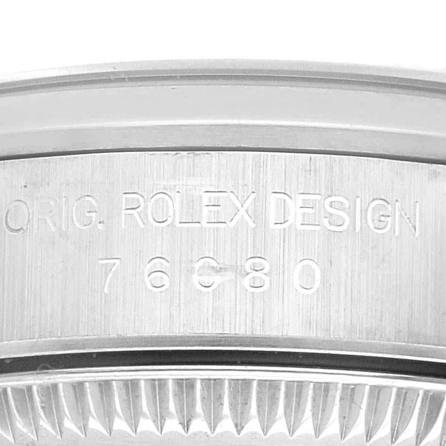 This close-up angle shows the engraved case side and part of the bezel of the Rolex Oyster Perpetual 76080 Women's Stainless Steel Blue Dial 76080 Women's Stainless Steel Blue Dial model.