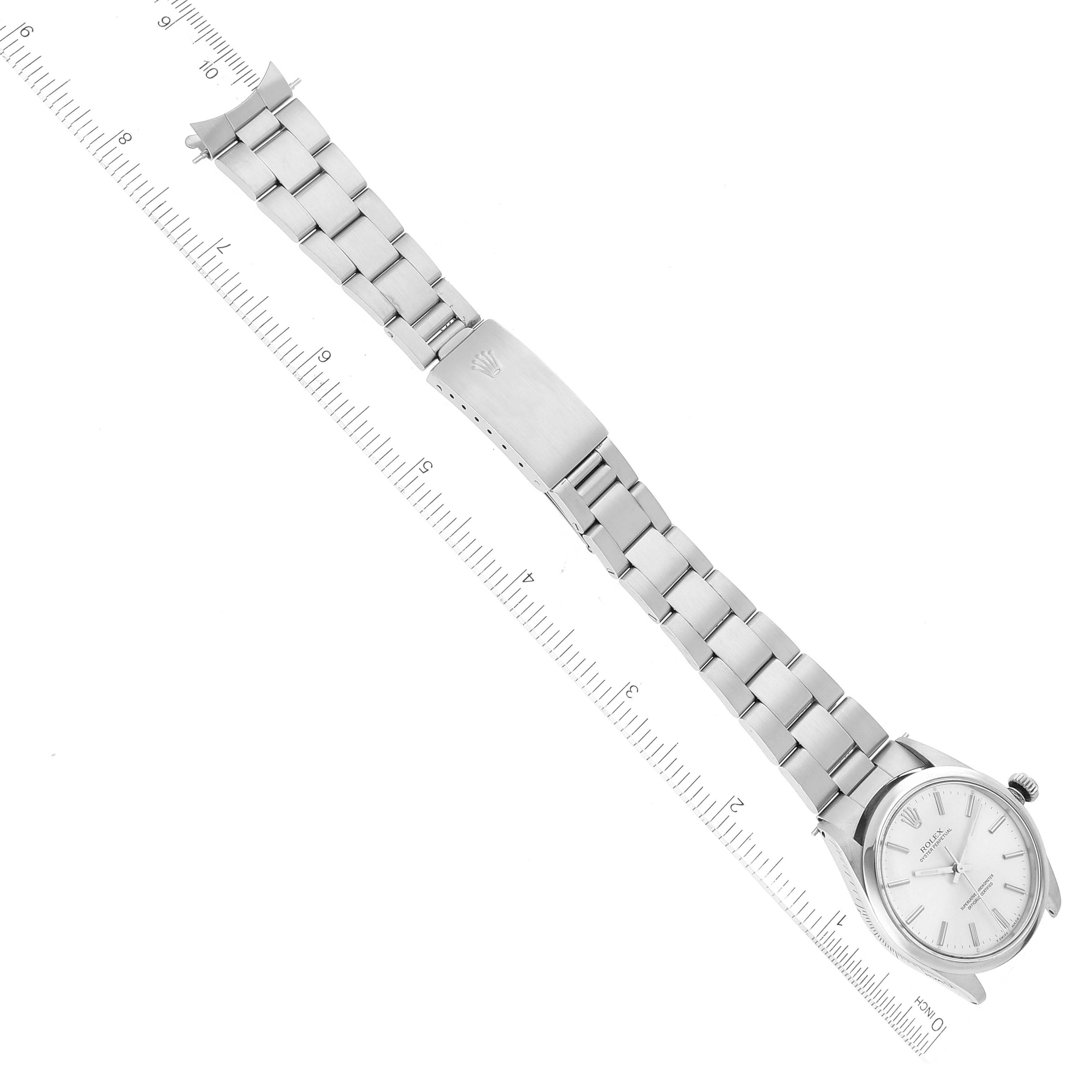 The image shows a Rolex Vintage Collection 1002 Men's Stainless Steel Silver Dial 1002 Men's Stainless Steel Silver Dial watch from a top-down angle, highlighting the face, bracelet, and clasp with a ruler for scale.