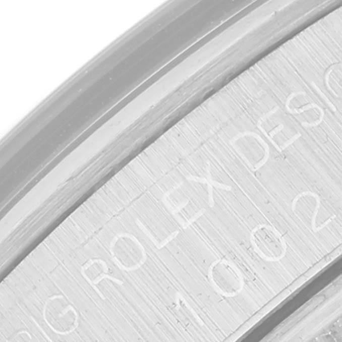 The image shows a close-up angle of the edge of the casing for the Rolex Vintage Collection 1002 Men's Stainless Steel Silver Dial 1002 Men's Stainless Steel Silver Dial model, displaying engraved text.