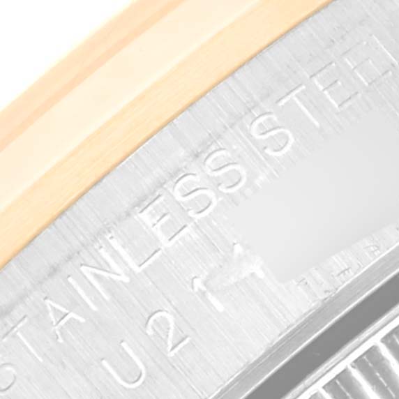 This image shows a close-up of the stainless steel and engraved text part of an Oyster Perpetual model by Rolex.