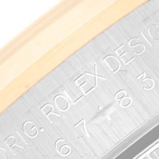 The image shows a macro shot of the engraved text "ROLEX DESIGN" on the case of the Rolex Oyster Perpetual 67183 Women's Steel and Gold (two tone) Blue Dial 67183 Women's Steel and Gold (two tone) Blue Dial watch.