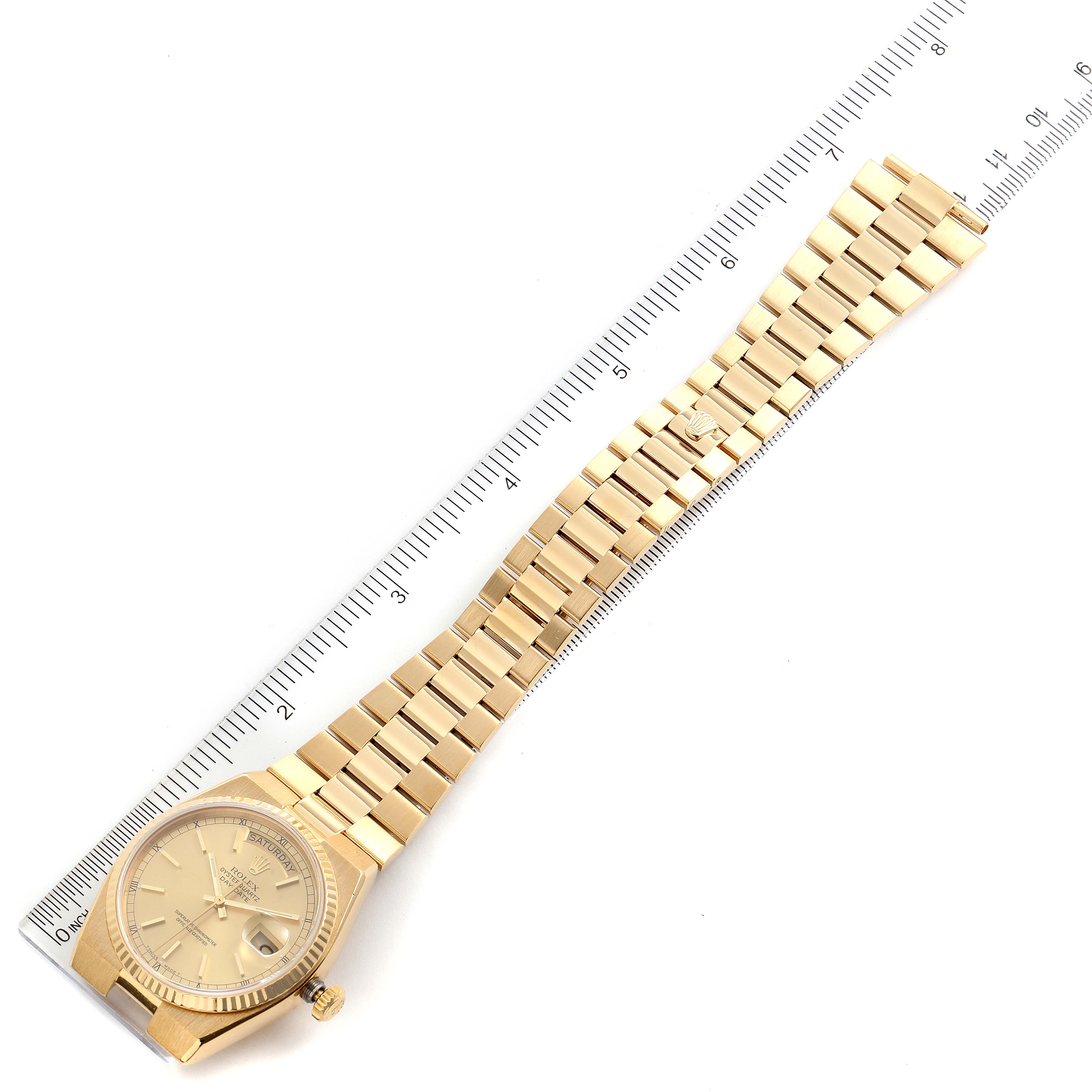 The image shows a Rolex President 19018 Men's Yellow Gold Champagne Dial 19018 Men's Yellow Gold Champagne Dial model watch laid flat with its band extended, alongside a ruler for scale.